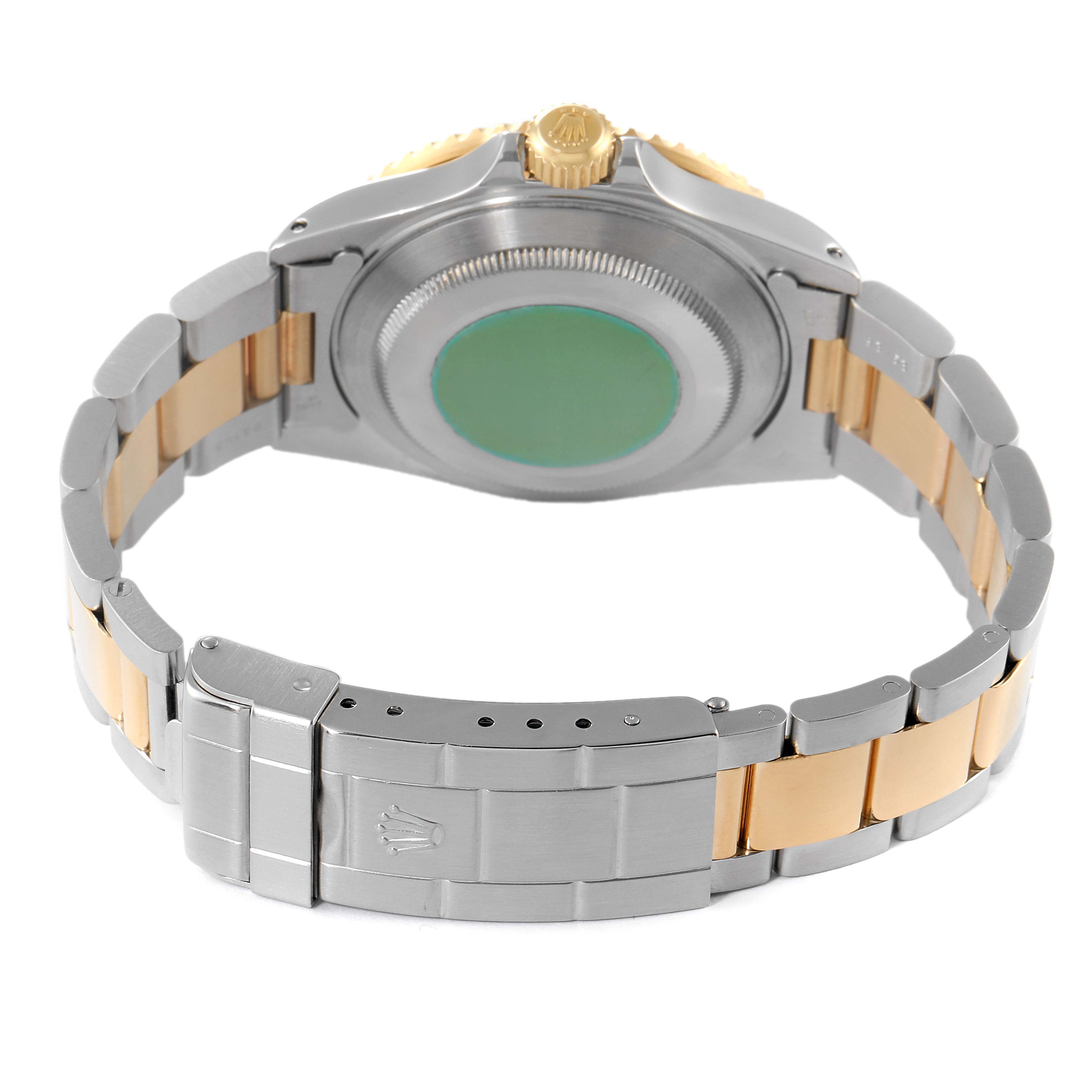 The image shows the back side of a Rolex Submariner 16613 Men's Steel and Gold (two tone) Black Dial 16613 Men's Steel and Gold (two tone) Black Dial, featuring its case back, crown, and two-tone bracelet with a clasp.