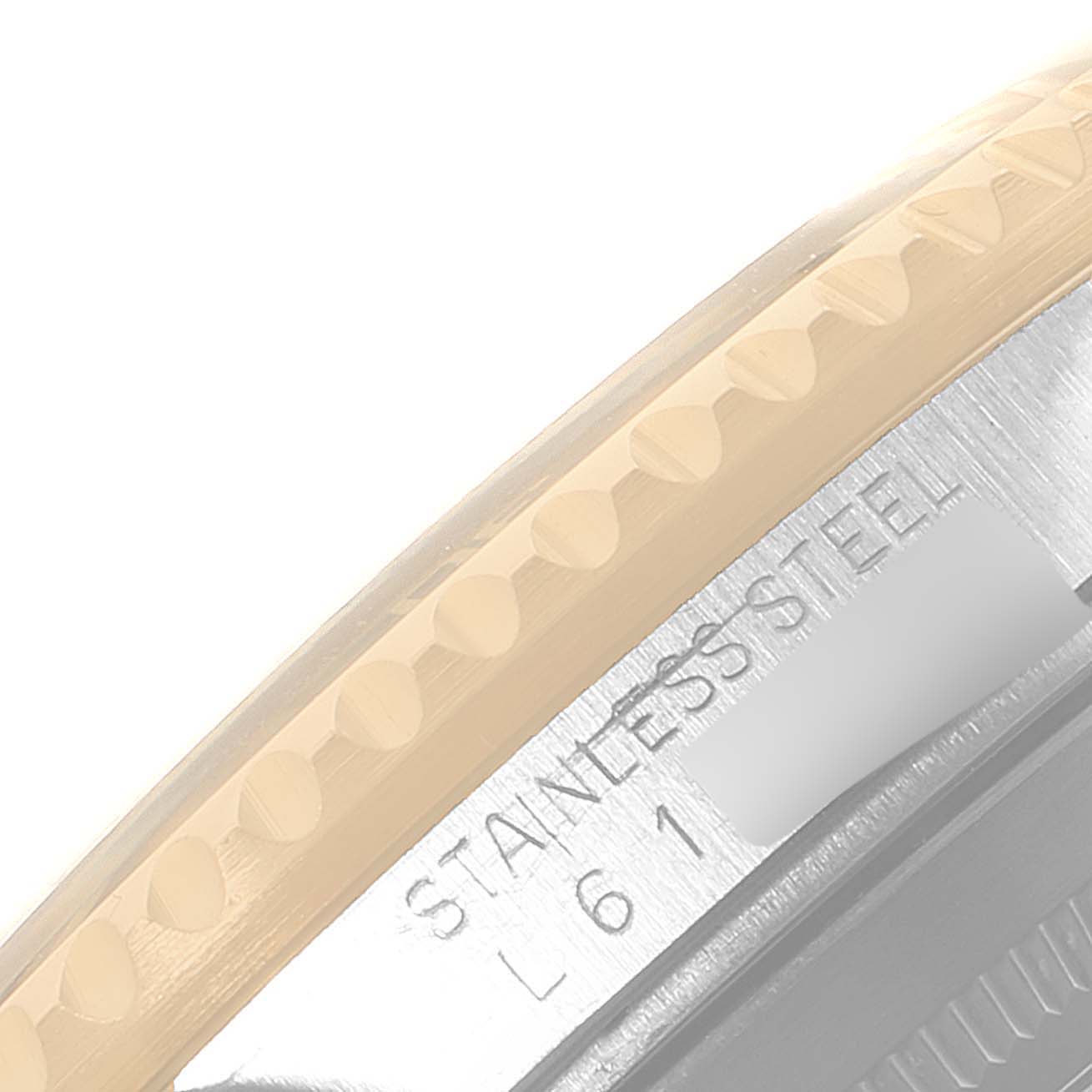 This image shows a close-up of the stainless steel casing and part of the bezel of a Rolex Submariner 16613 Men's Steel and Gold (two tone) Black Dial 16613 Men's Steel and Gold (two tone) Black Dial.