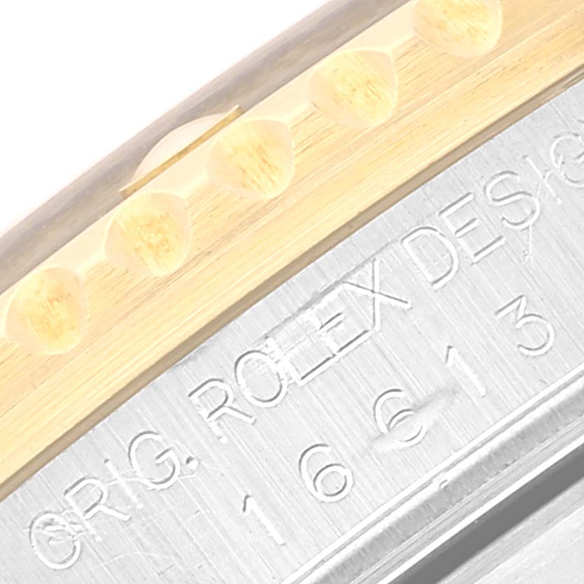 This image shows a close-up of the bezel and case of a Rolex Submariner 16613 Men's Steel and Gold (two tone) Black Dial 16613 Men's Steel and Gold (two tone) Black Dial watch, highlighting the edge engraving details.