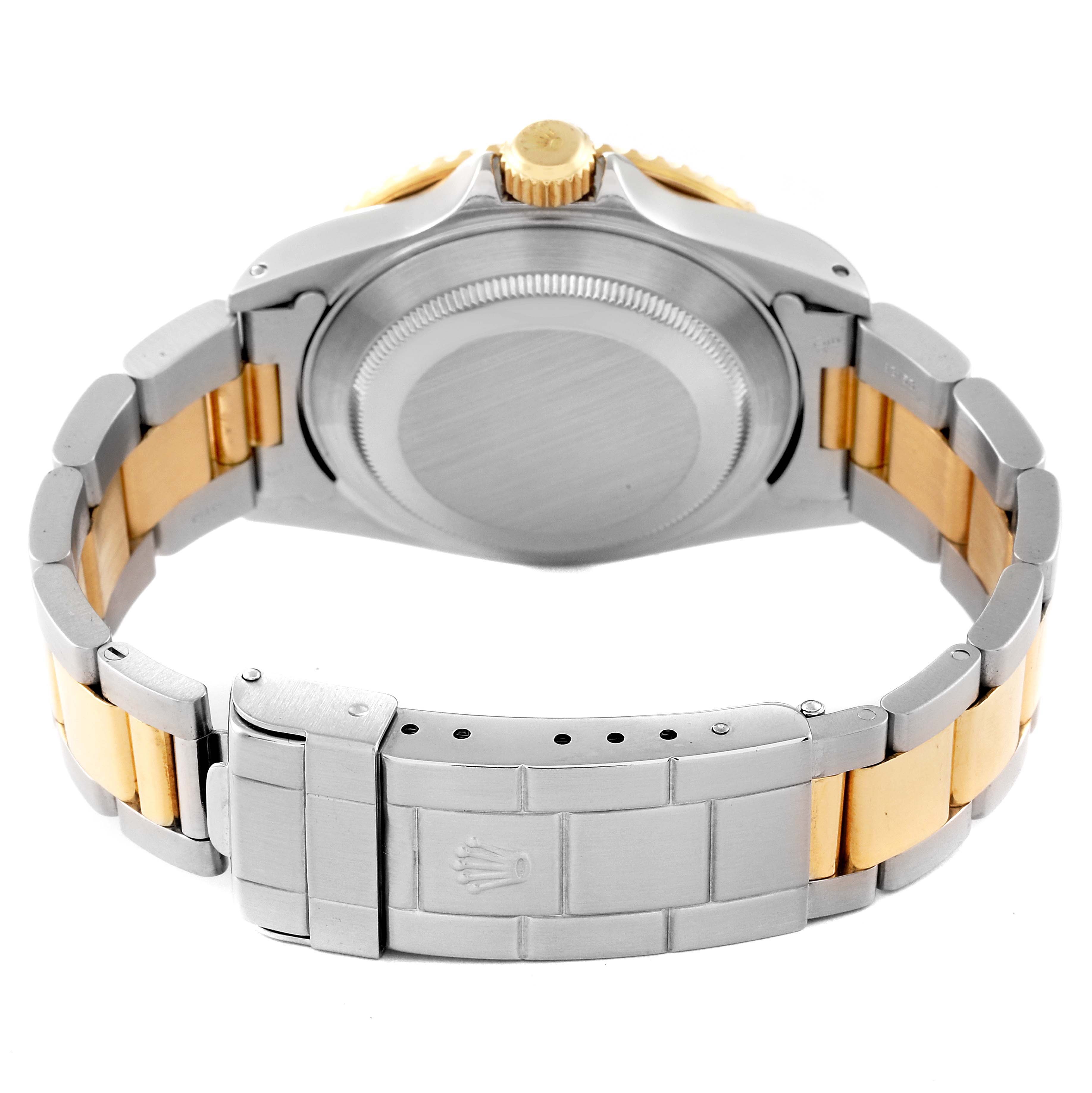 The image shows the back view of the Rolex Submariner 16613 Men's Steel and Gold (two tone) Champagne Dial 16613 Men's Steel and Gold (two tone) Champagne Dial watch, highlighting its case, crown, and two-tone bracelet with the clasp.