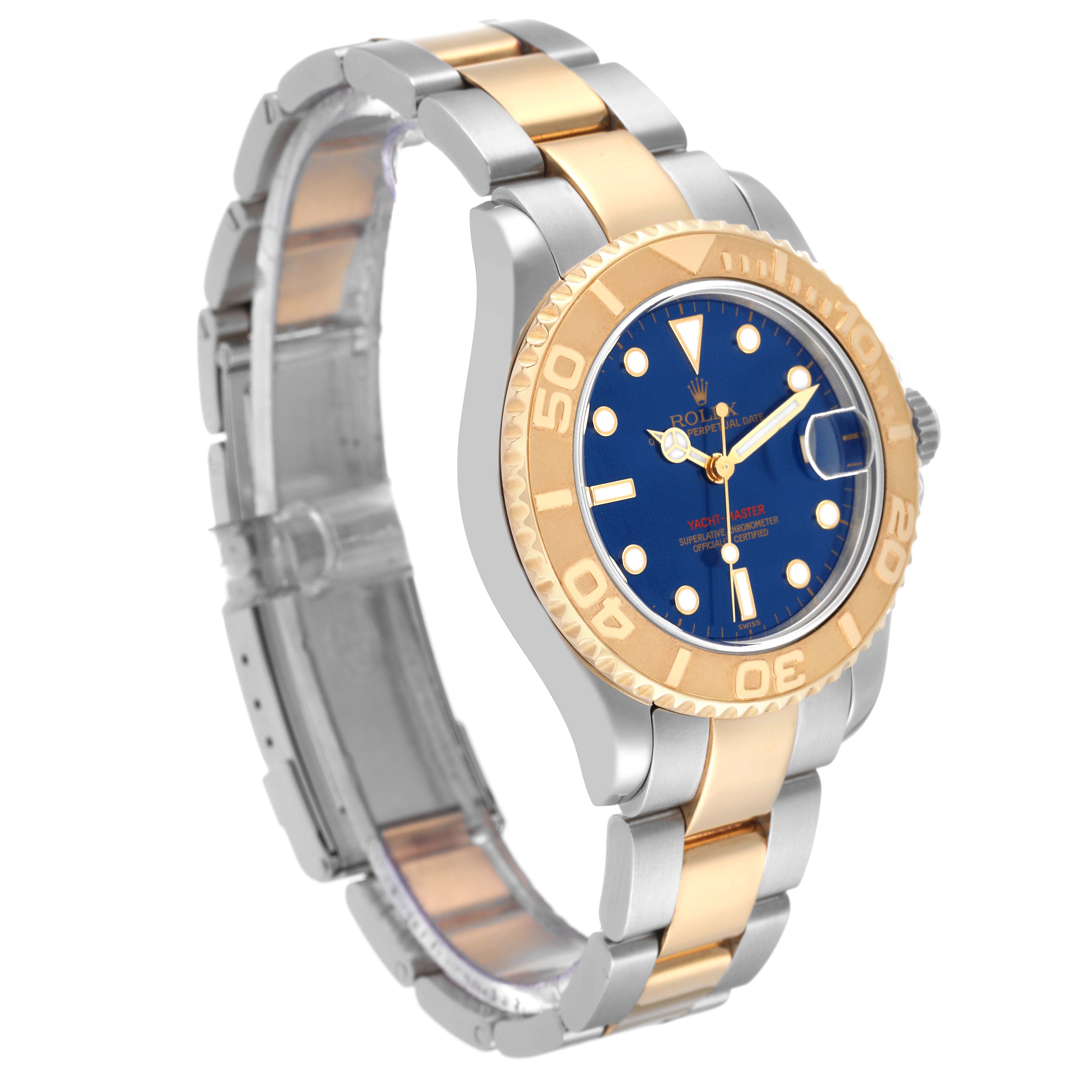 This Rolex Yacht-Master 68623 Men's Steel and Gold (two tone) Blue Dial 68623 Men's Steel and Gold (two tone) Blue Dial watch is shown at a slight side angle, highlighting its two-tone bracelet, blue dial, and bezel.