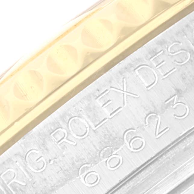 The image shows a close-up angle of the bezel and engraved serial number on the Yacht-Master model by Rolex.