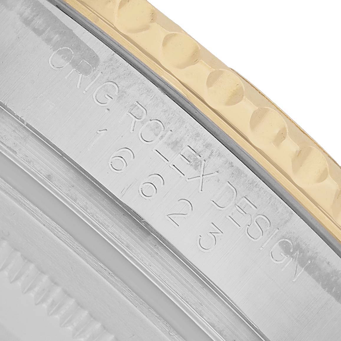 The image shows an angled close-up of the case side of a Rolex Yacht-Master 16623 Men's Steel and Gold (two tone) White Dial, highlighting the model number engraving.