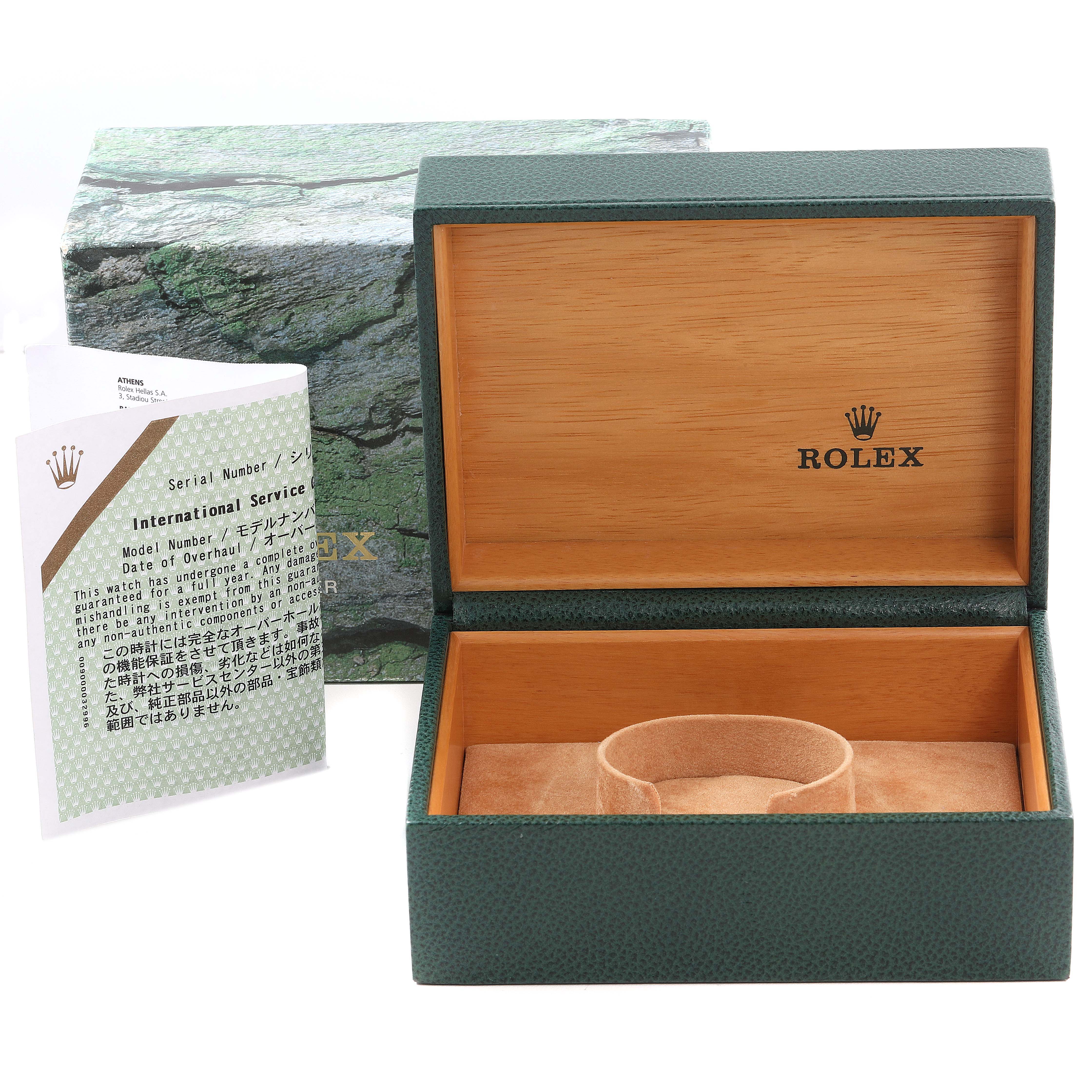 The image shows an open Rolex watch box for the Yacht-Master model, alongside its international service document.