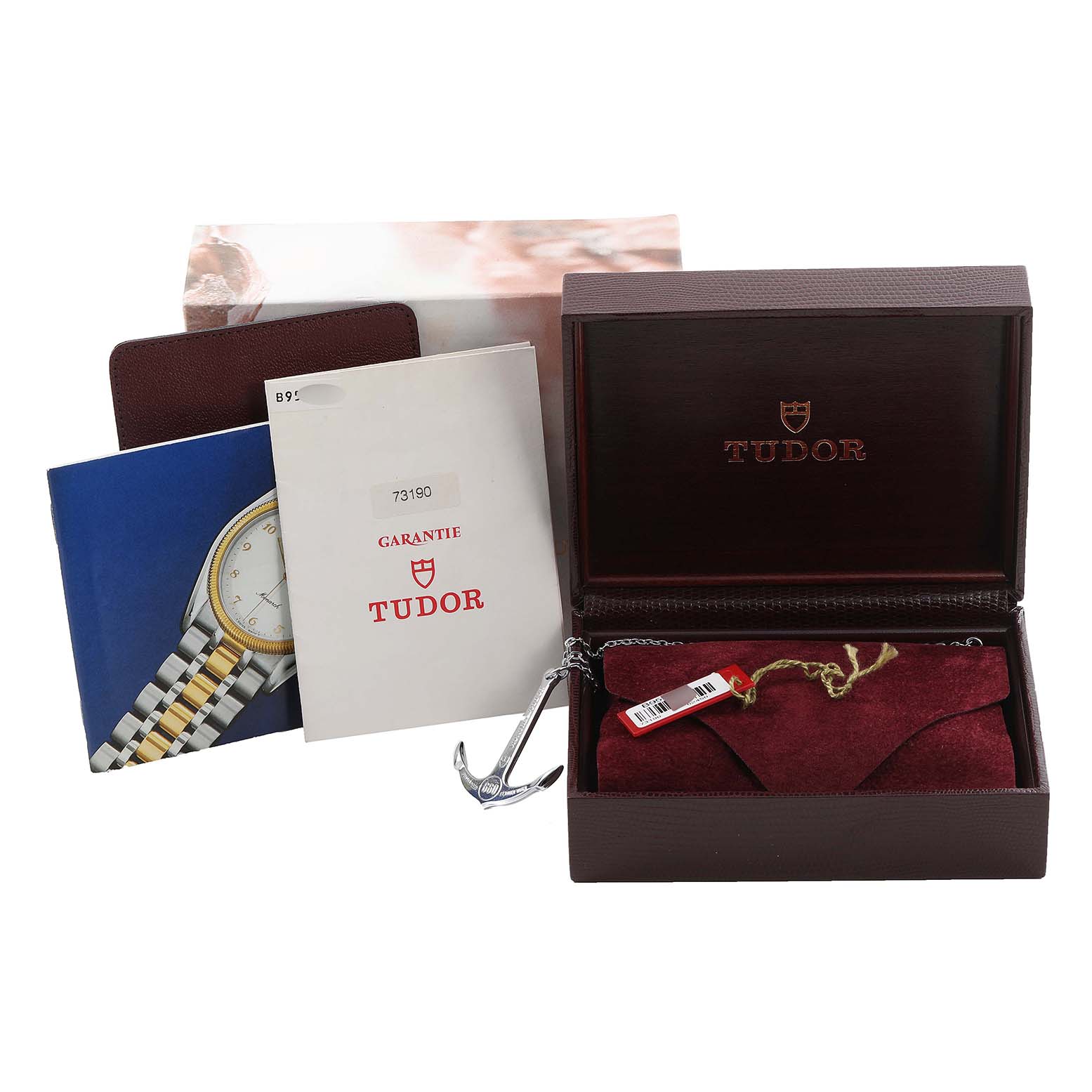 The image shows the Tudor Prince watch box, warranty papers, and accessories like a red pouch and an anchor tag.
