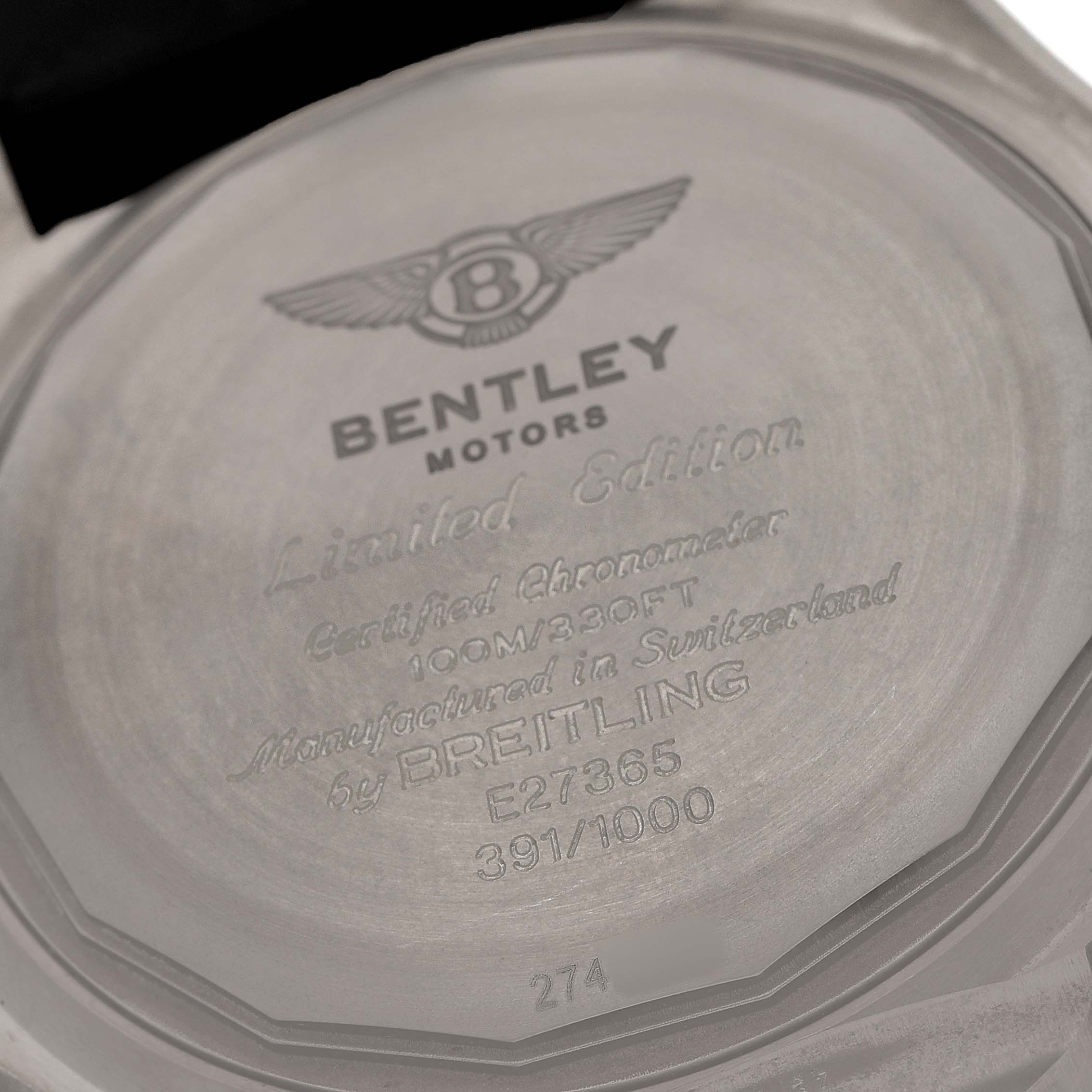 The image shows the back of a Breitling Bentley E27365 Men's Titanium Black Dial watch with engraved details mentioning it as a limited edition.