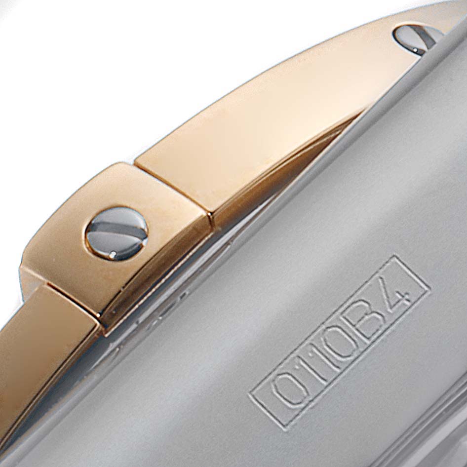 This image shows a close-up of the two-tone metal bracelet and engraved serial number of the Breitling Chronomat CB0110 Men's Steel and Gold (two tone) Brown Dial CB0110 Men's Steel and Gold (two tone) Brown Dial model.