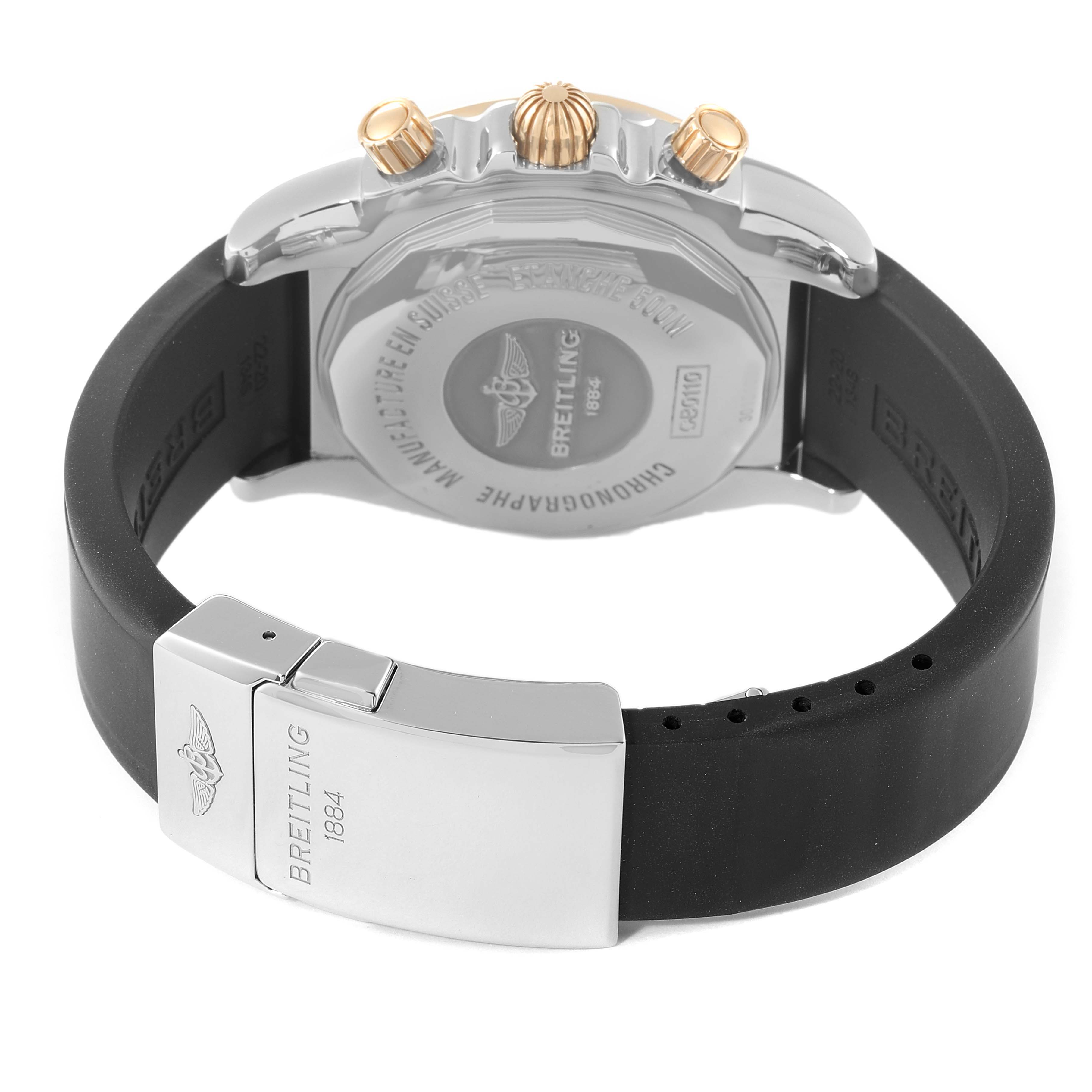 The image shows the back case and clasp of a Breitling Chronomat CB0110 Men's Steel and Gold (two tone) Brown Dial CB0110 Men's Steel and Gold (two tone) Brown Dial watch, highlighting the rubber strap and chronograph pushers.