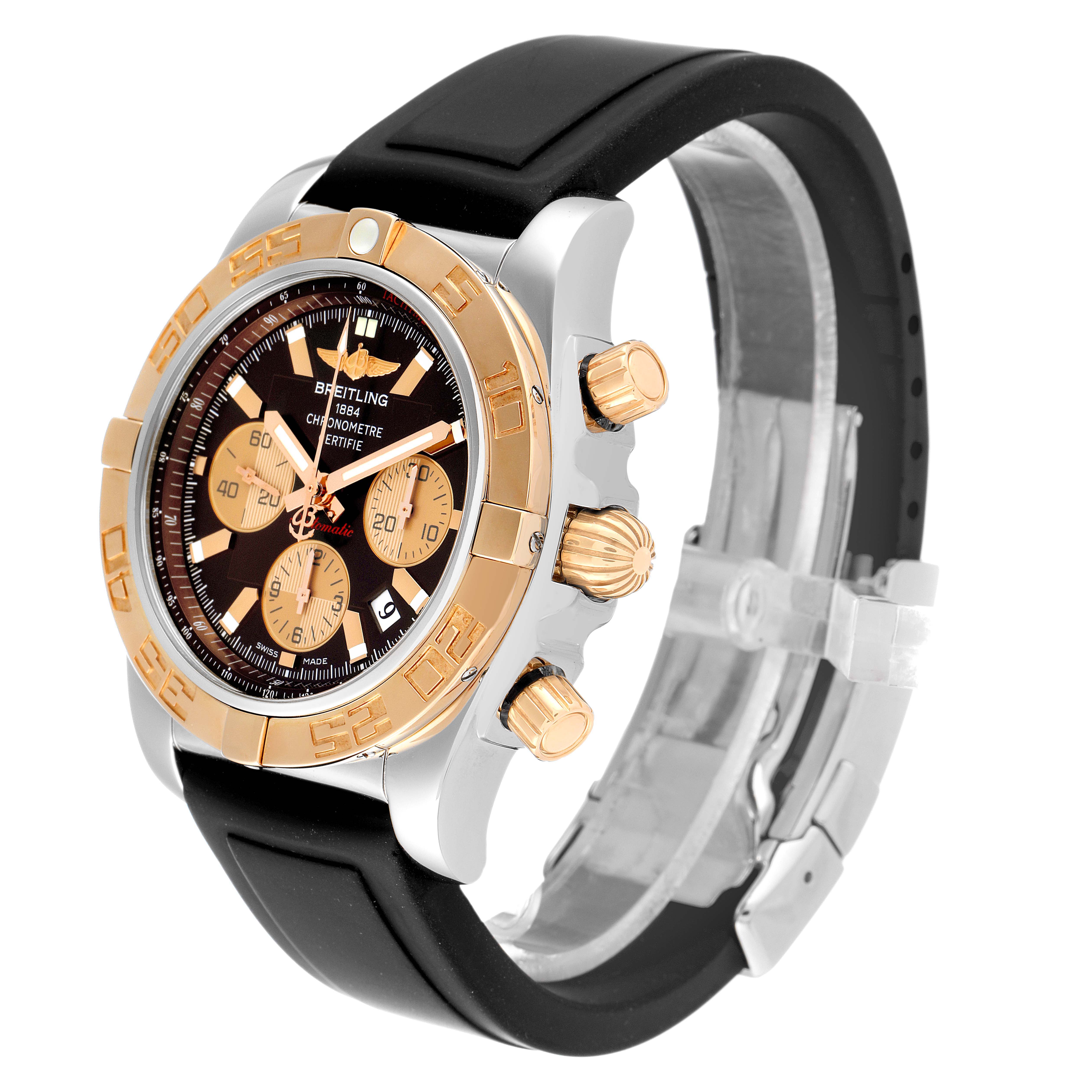 The photo shows a side angle of a Breitling Chronomat CB0110 Men's Steel and Gold (two tone) Brown Dial CB0110 Men's Steel and Gold (two tone) Brown Dial watch, highlighting its bezel, crown, pushers, and black strap.