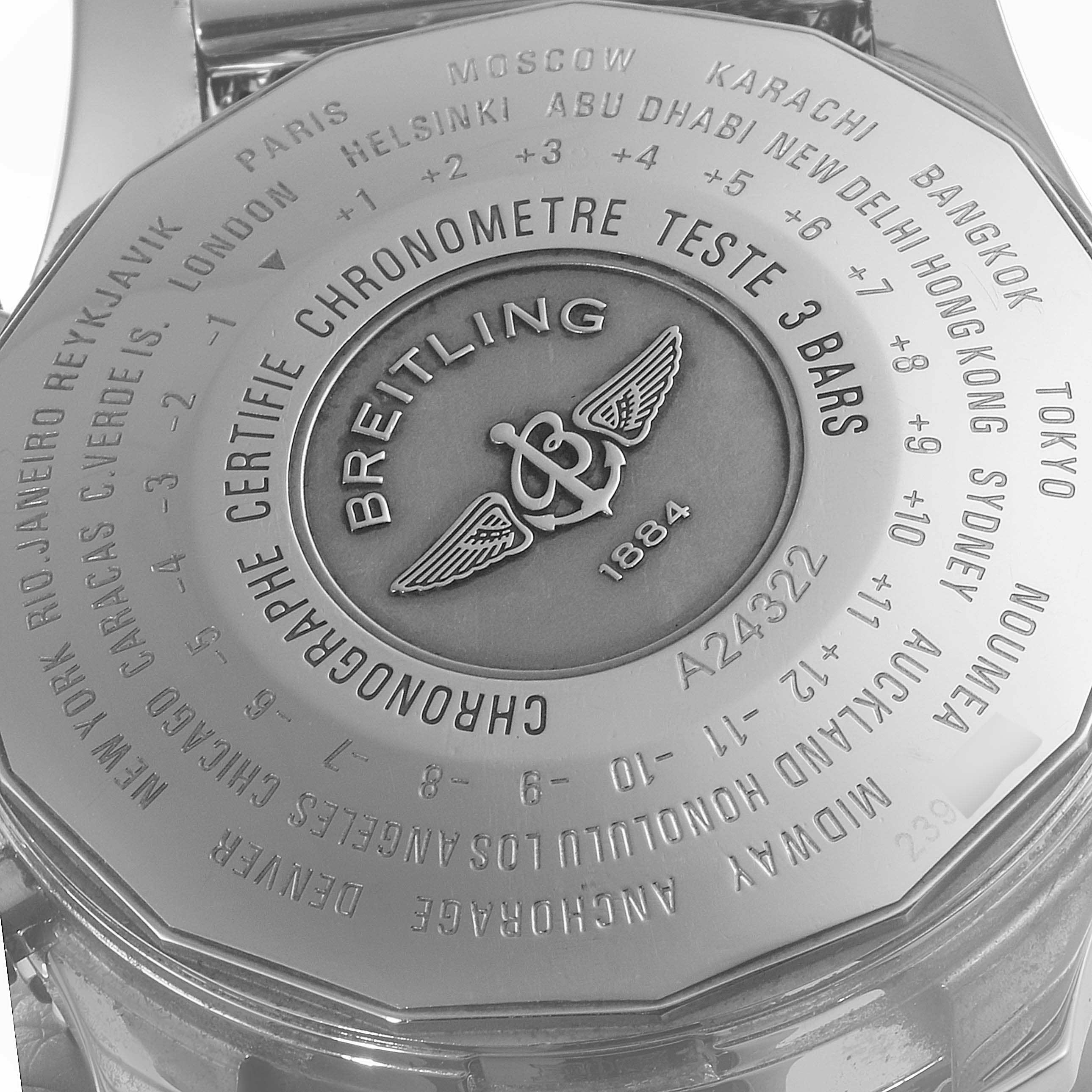 The image shows the back case of a Breitling Navitimer A24322 Men's Stainless Steel Silver Dial A24322 Men's Stainless Steel Silver Dial watch, displaying city names and certification details.
