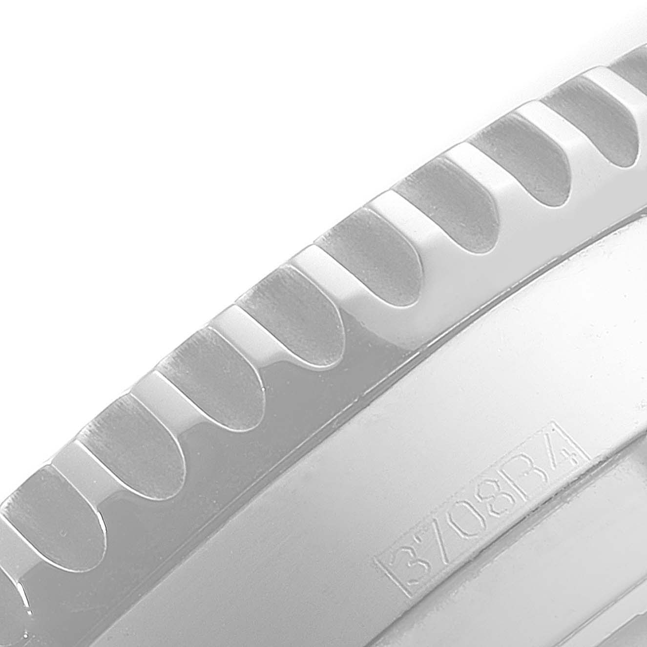 The image shows a close-up angle of the bezel and part of the casing of a Breitling Navitimer A24322 Men's Stainless Steel Silver Dial A24322 Men's Stainless Steel Silver Dial watch.