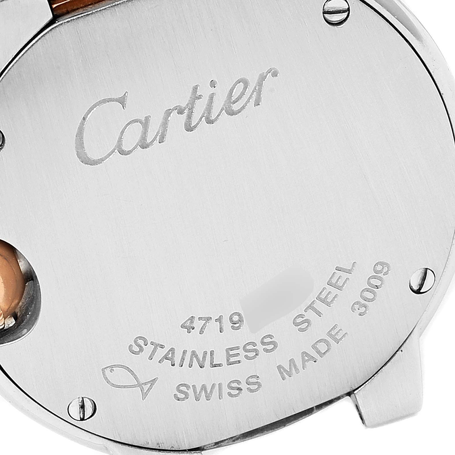 This image shows the back case of a Cartier Ballon Bleu WE902030 Women's Steel and Gold (two tone) Silver Dial WE902030 Women's Steel and Gold (two tone) Silver Dial watch, displaying engravings and screws.