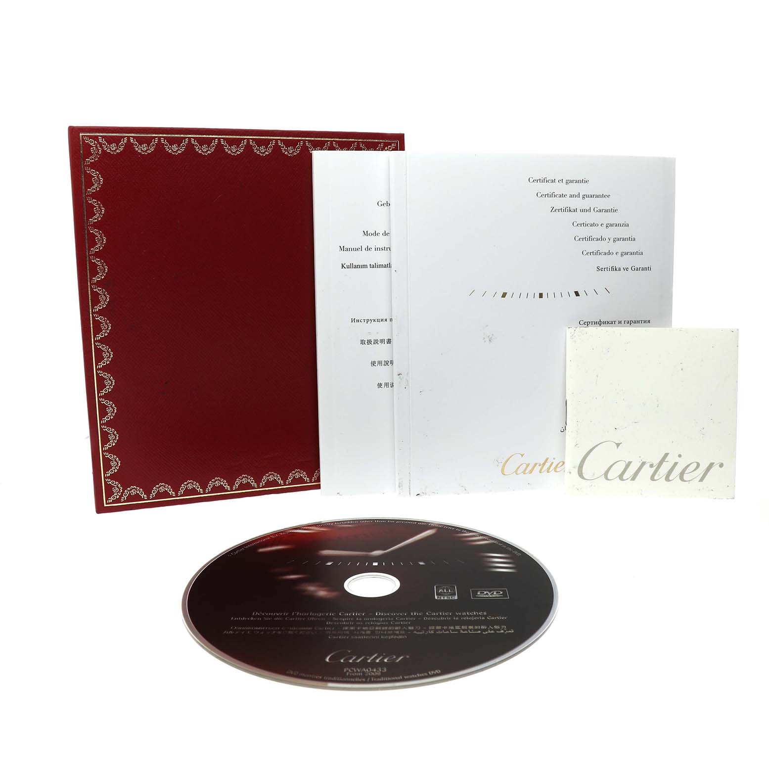 The image shows the Cartier Roadster W62017V3 Women's Stainless Steel Pink Dial model watch accessories including a warranty booklet, manual, and disc.