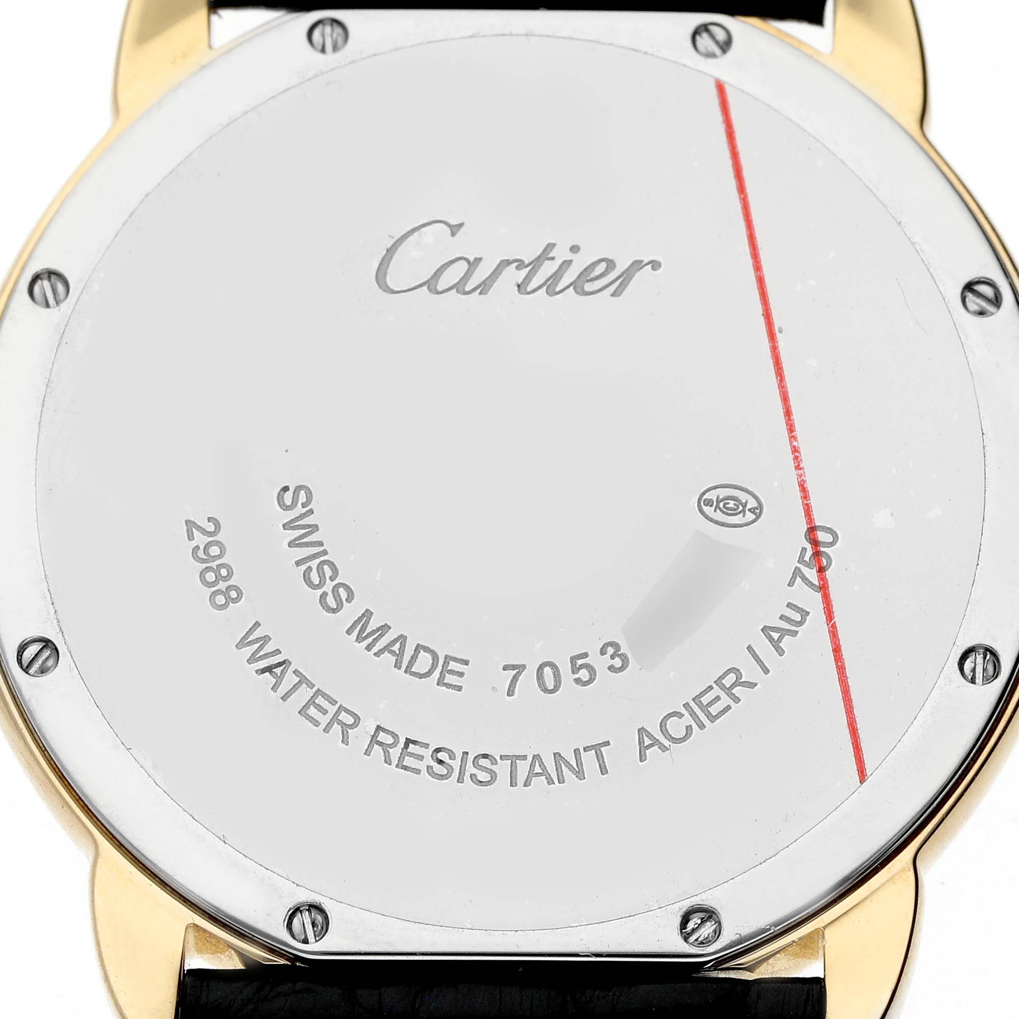 The image shows the back of a Cartier Ronde W6700455 Men's Yellow Gold Silver Dial watch, focusing on its engravings and screws.