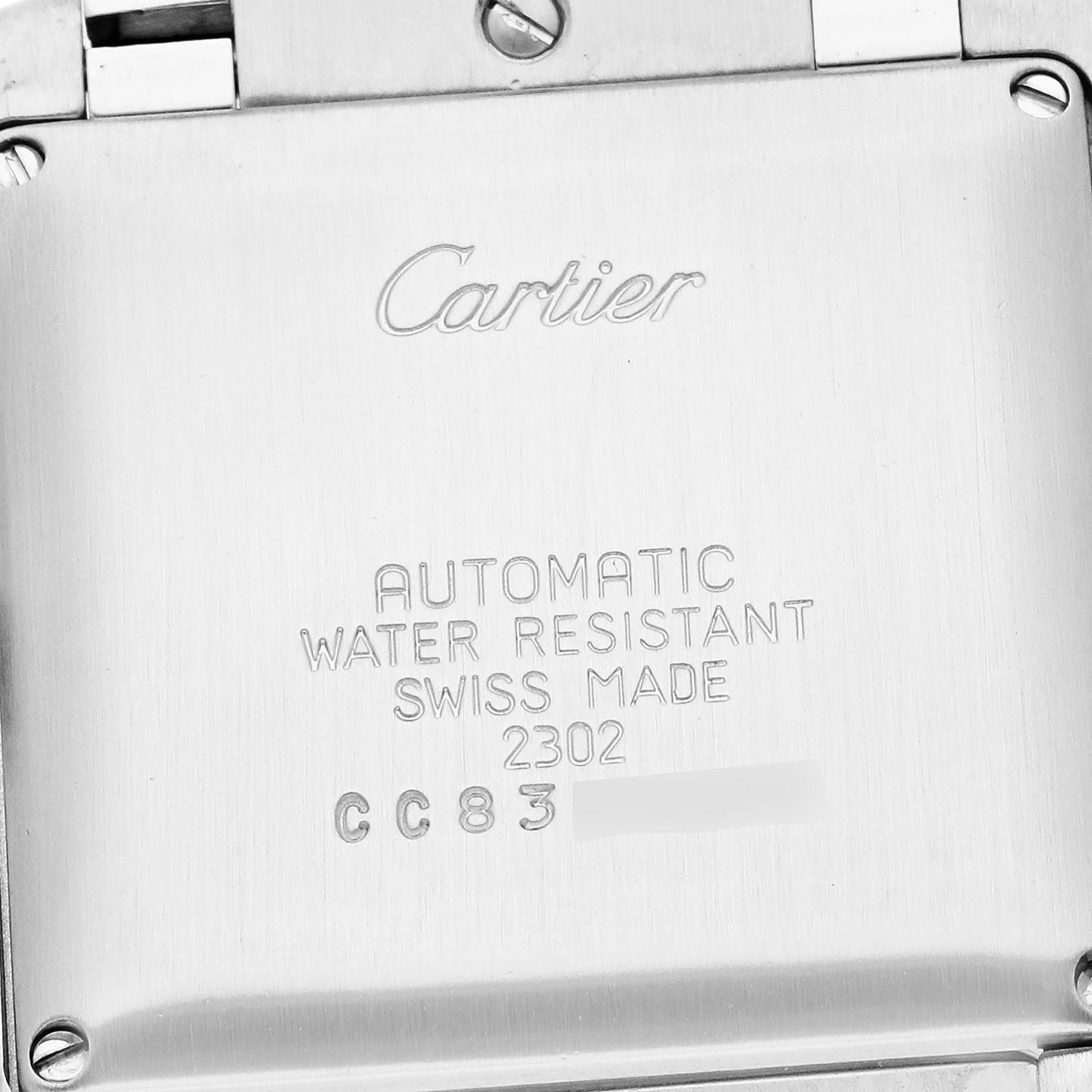The image shows the back of a Cartier Tank Française watch, highlighting the model
s engraved details.