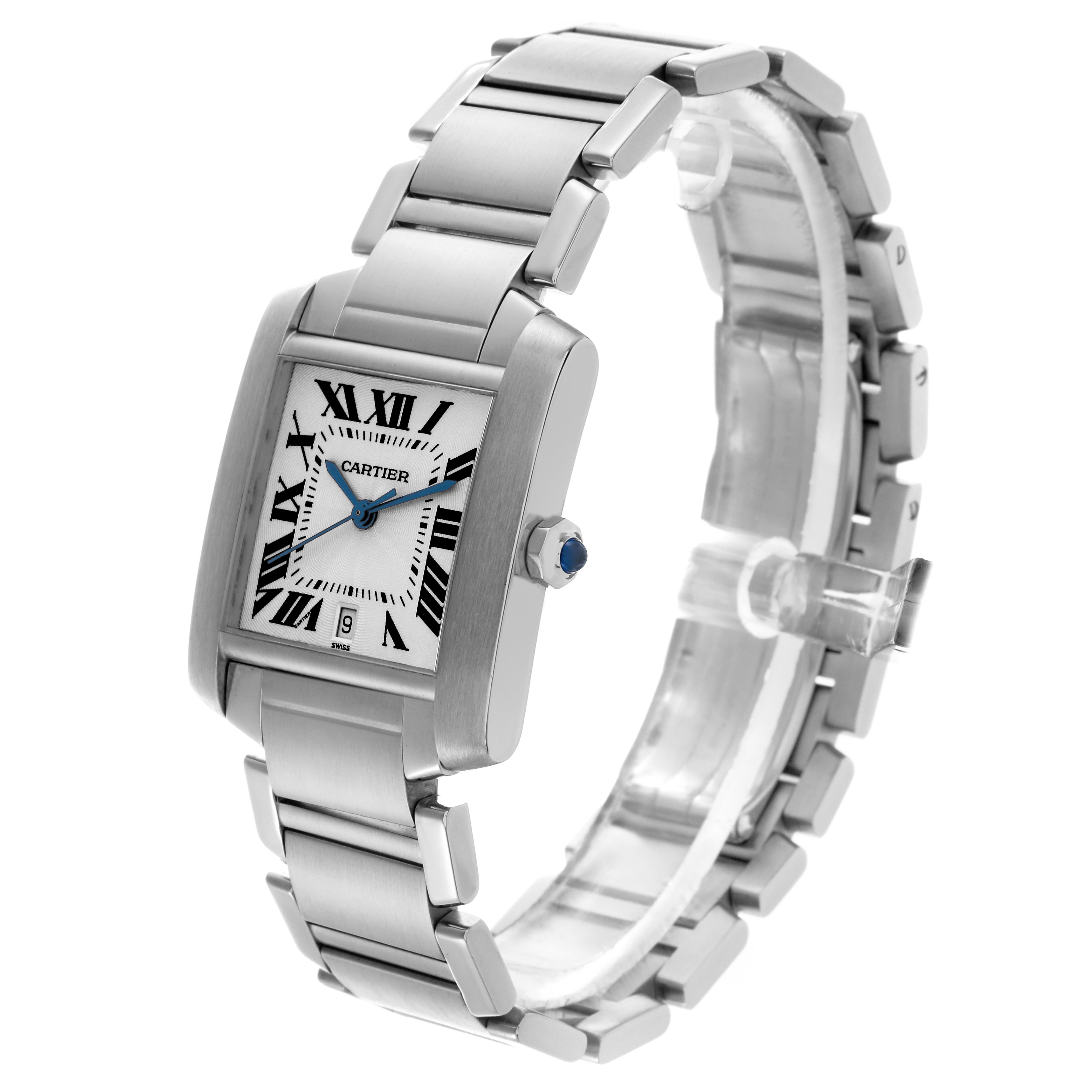 The Cartier Tank Française watch is shown at an angle highlighting the face, Roman numerals, blue hands, and metal bracelet.