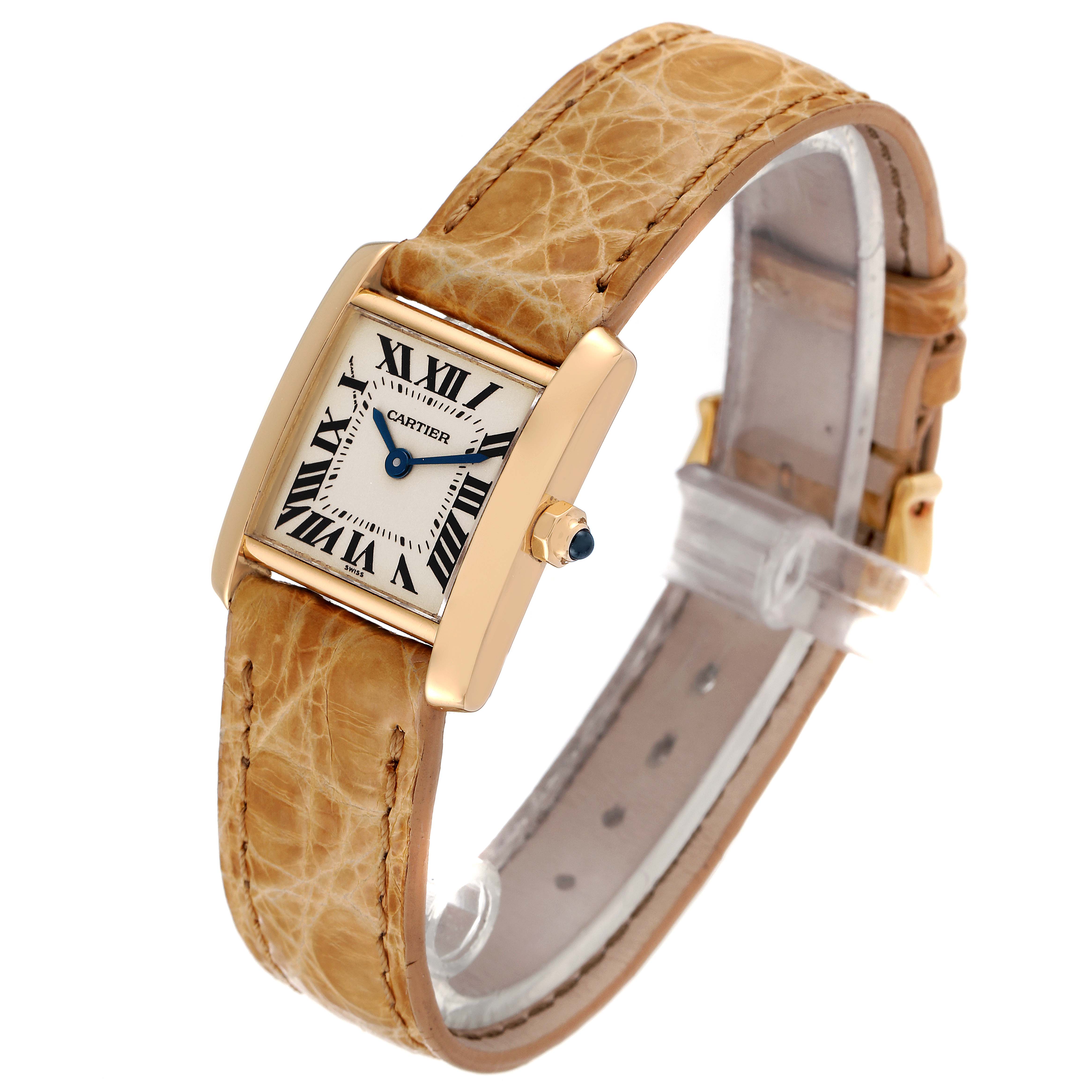 This Cartier Tank Française watch is shown at a slight angle displaying the dial, case, and tan leather strap.