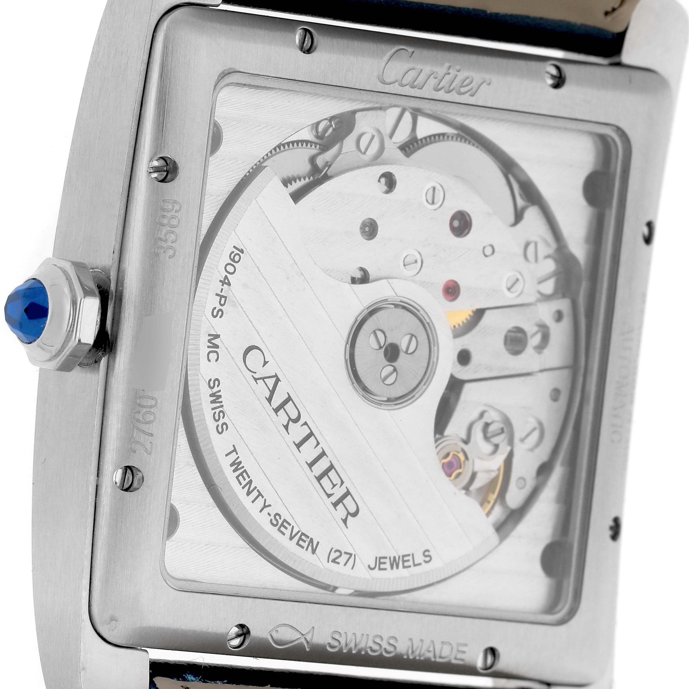 The Cartier Tank MC W5330003 Men's Stainless Steel Silver Dial watch is shown from the back, revealing its mechanical movement and details like the winding crown with a blue cabochon.