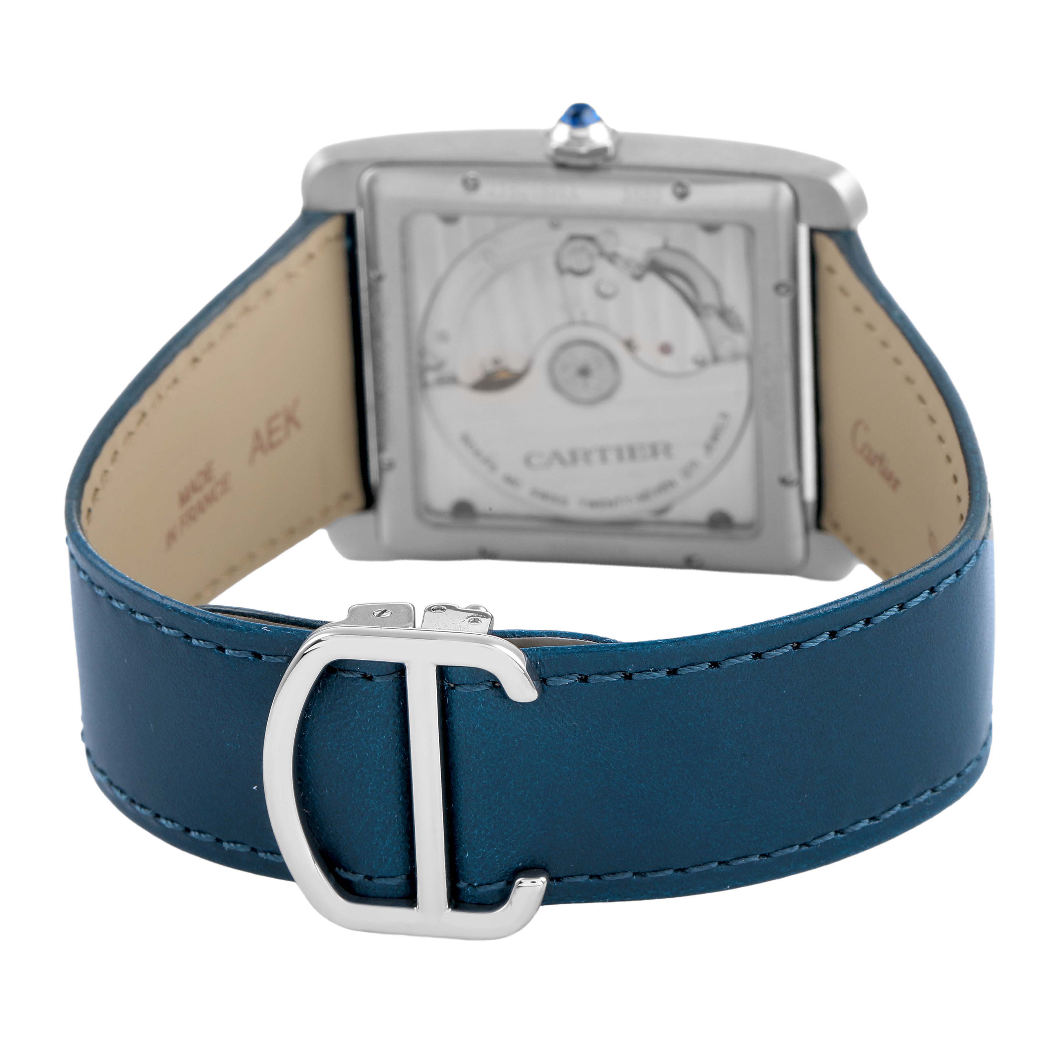 The image shows the back view of the Cartier Tank MC W5330003 Men's Stainless Steel Silver Dial watch, highlighting its movement and a blue leather strap with a buckle.