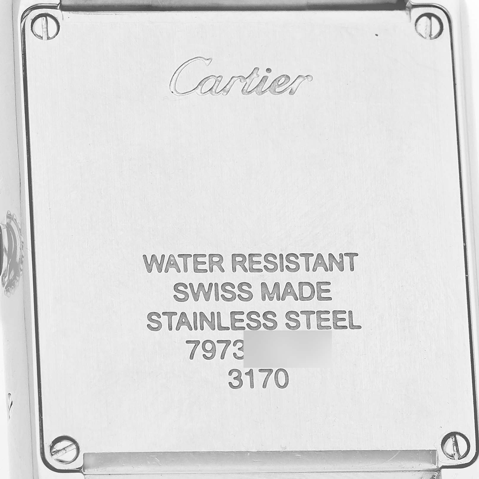 The image shows the case back of a Cartier Tank Solo W5200013 Women's Stainless Steel Silver Dial, displaying the brand, model specifications, and screws.