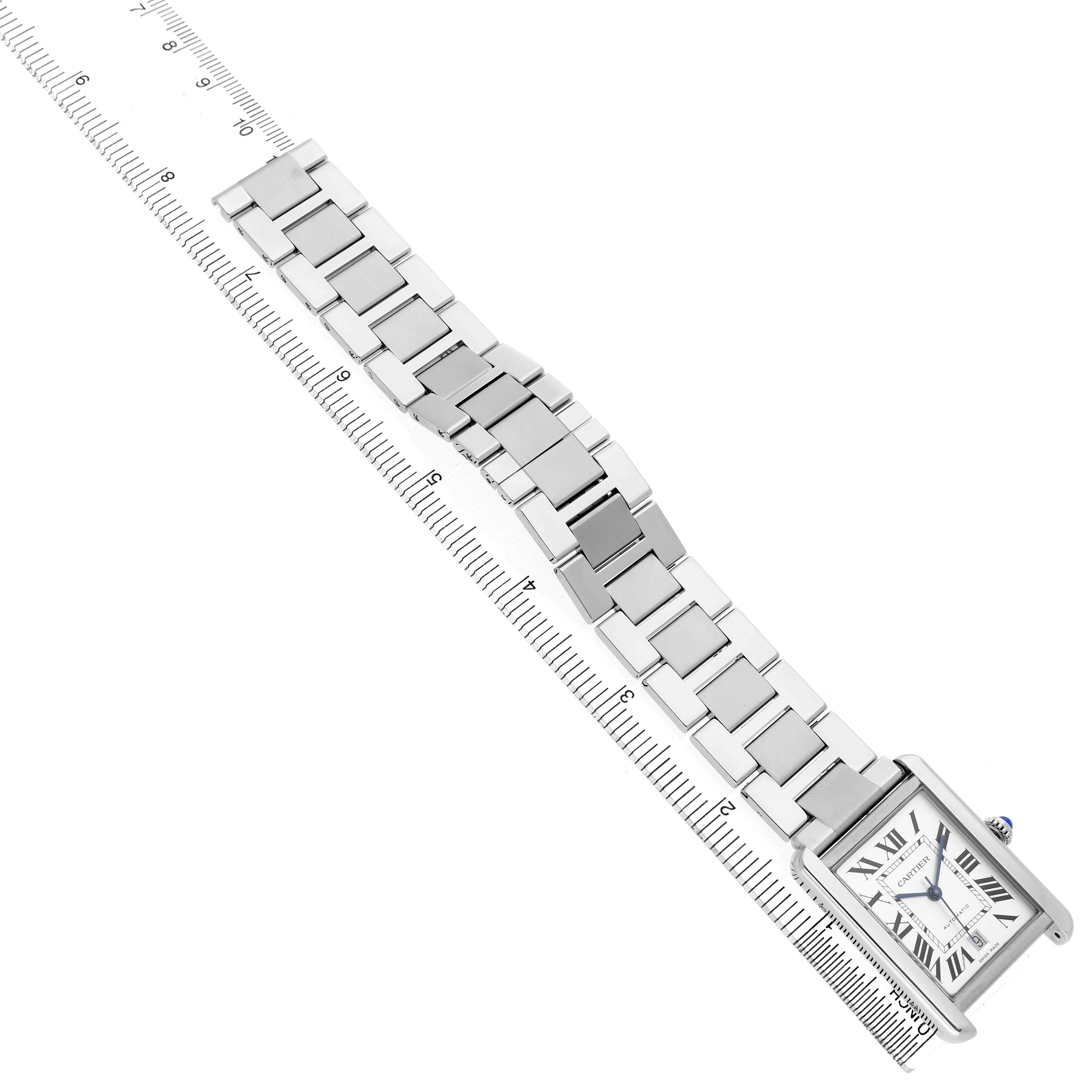 The Cartier Tank Solo W5200028 Men's Stainless Steel Silver Dial watch is shown at an angle displaying its face, bracelet, and crown along with a ruler for scale.