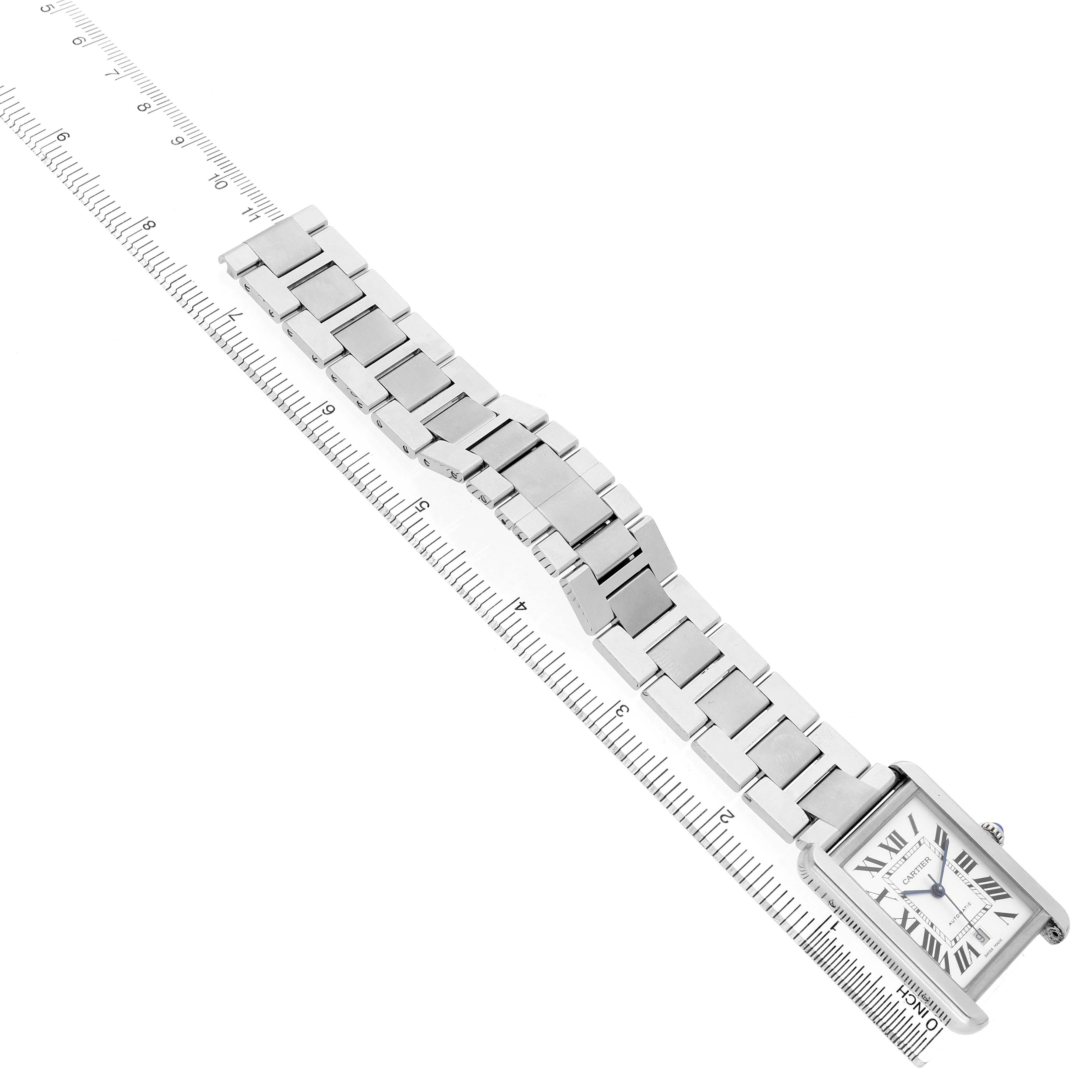 The Cartier Tank Solo W5200028 Men's Stainless Steel Silver Dial watch is shown from an angled top view, displaying the face, case, and metal bracelet alongside a ruler.