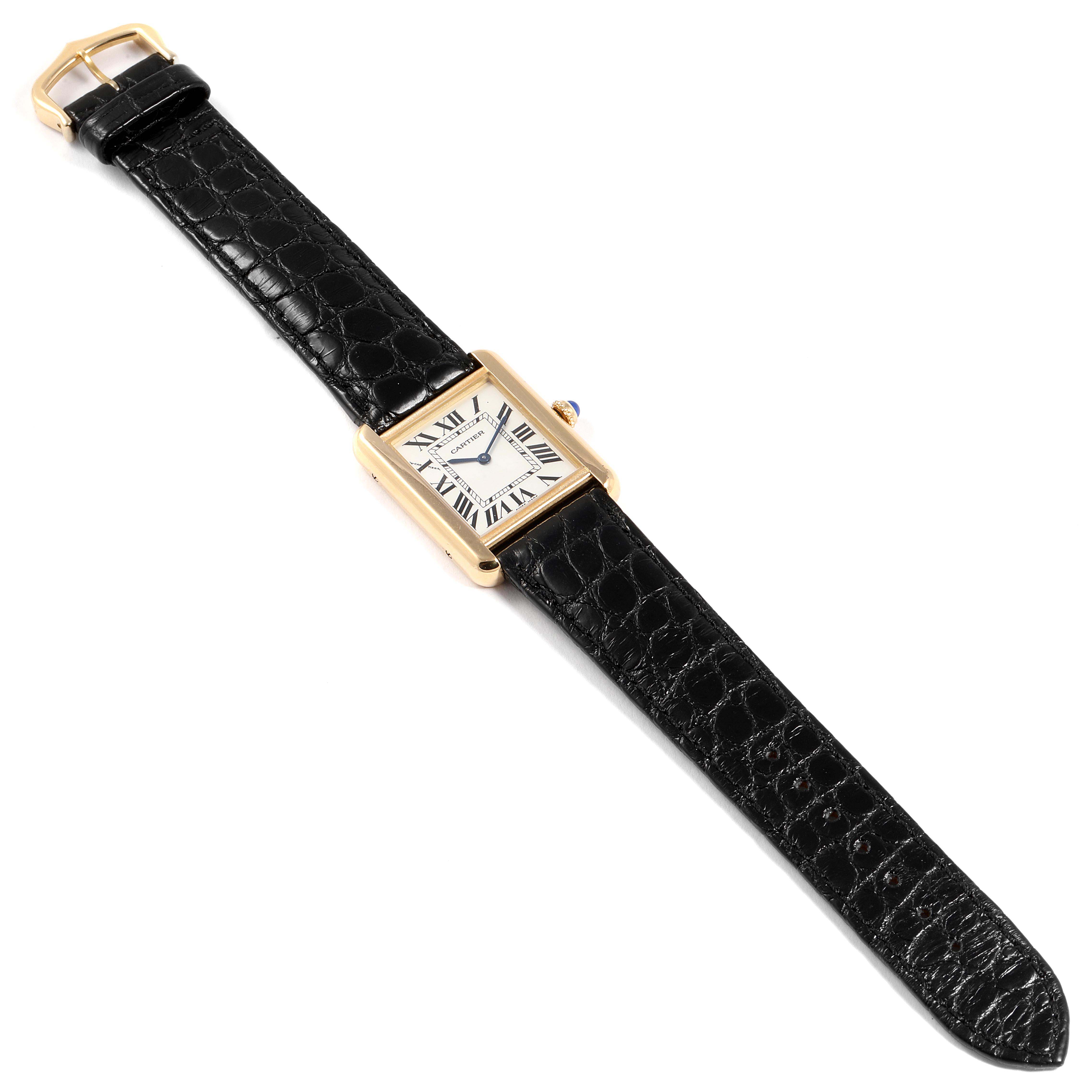 The image shows a Cartier Tank Solo W1018755 Women
s Yellow Gold Silver Dial W1018755 Women
s Yellow Gold Silver Dial watch with a rectangular face and a black leather strap laid flat.
