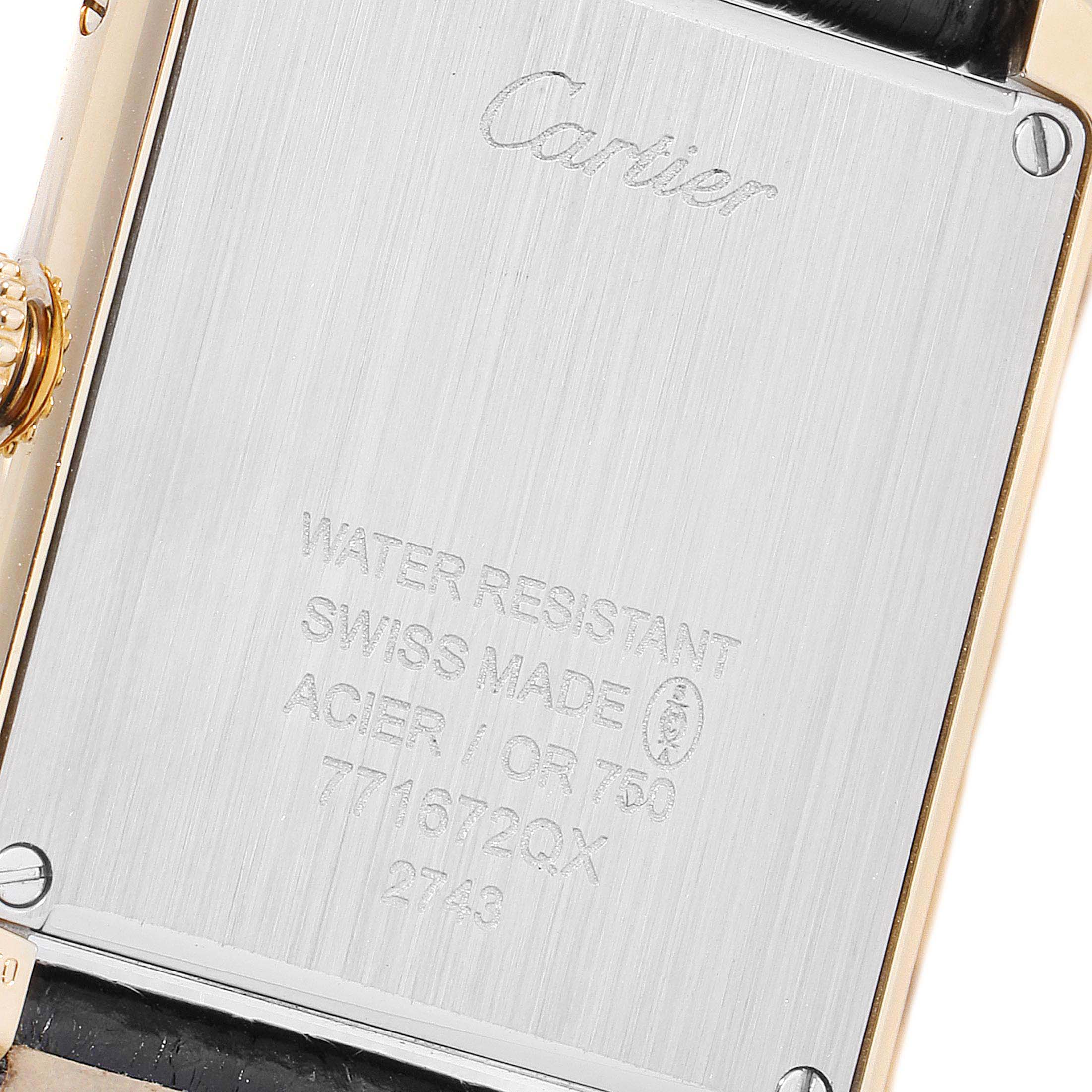 This is a close-up of the back of a Cartier Tank Solo W1018755 Women
s Yellow Gold Silver Dial W1018755 Women
s Yellow Gold Silver Dial watch, displaying engraving details and part of the strap.