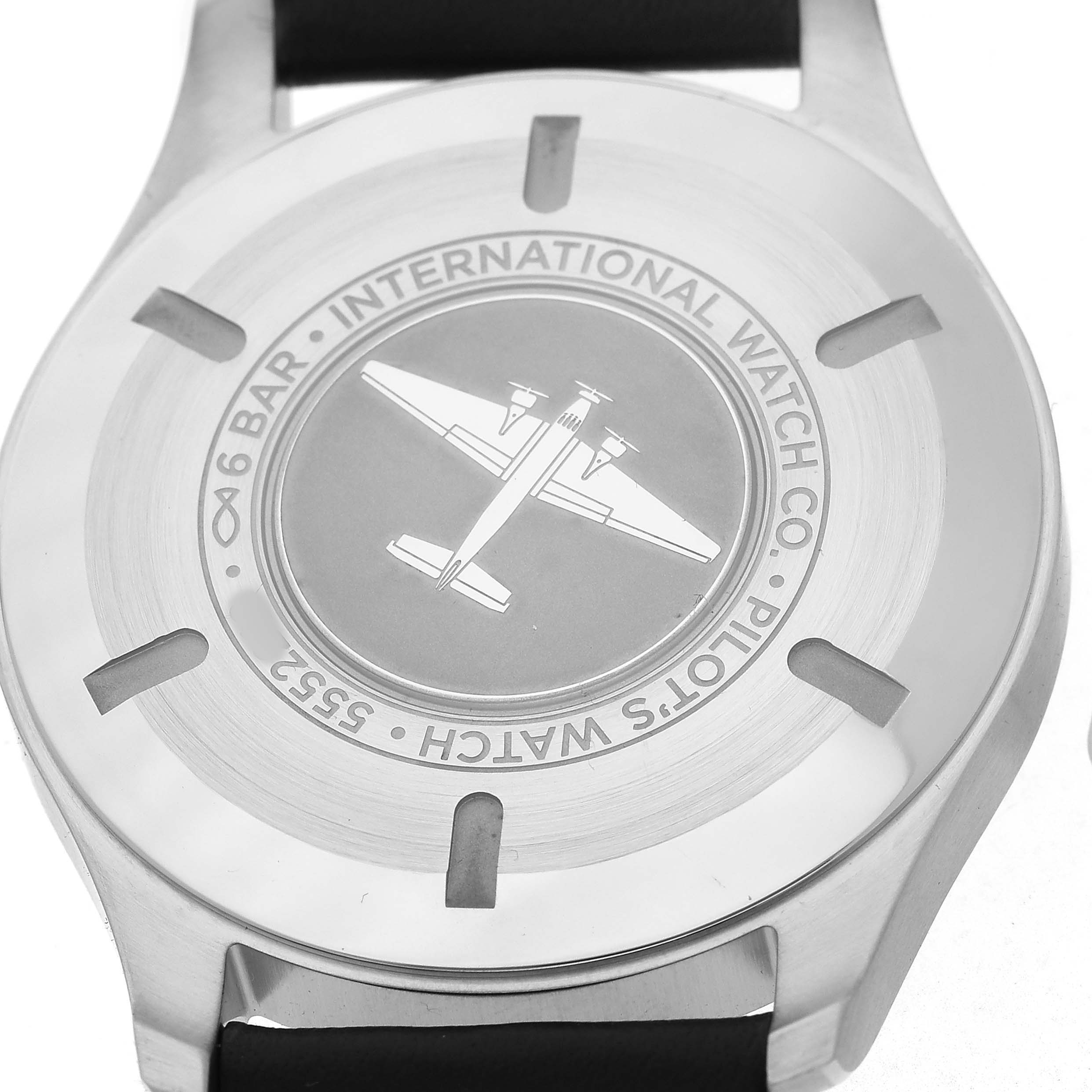 The image shows the back case of the IWC Pilot IW327001 Men's Stainless Steel Black Dial model watch, featuring an engraved airplane motif.