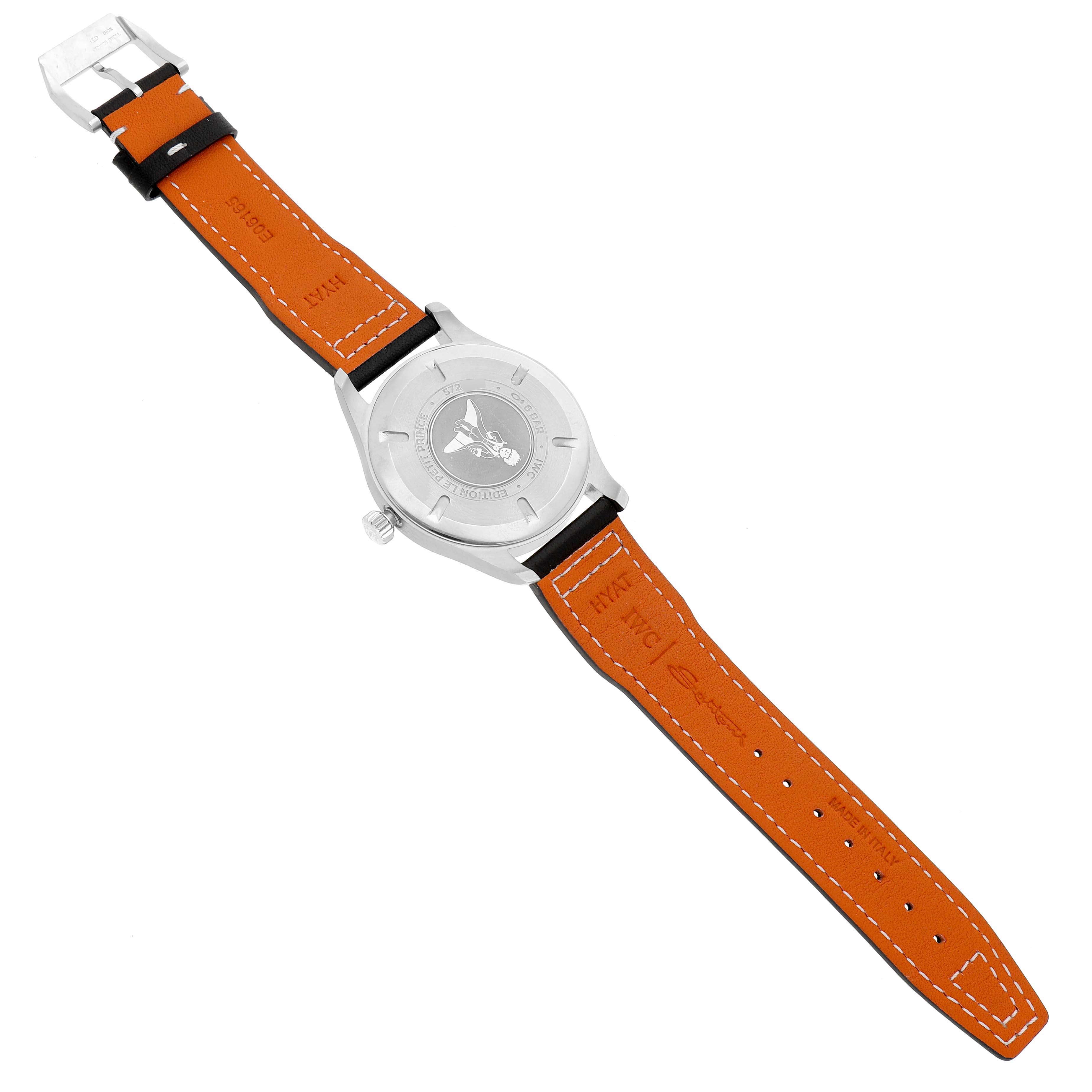 The IWC Pilot IW327010 Men's Stainless Steel Blue Dial model watch is shown from the back, highlighting the case back and the orange strap with visible stitching.