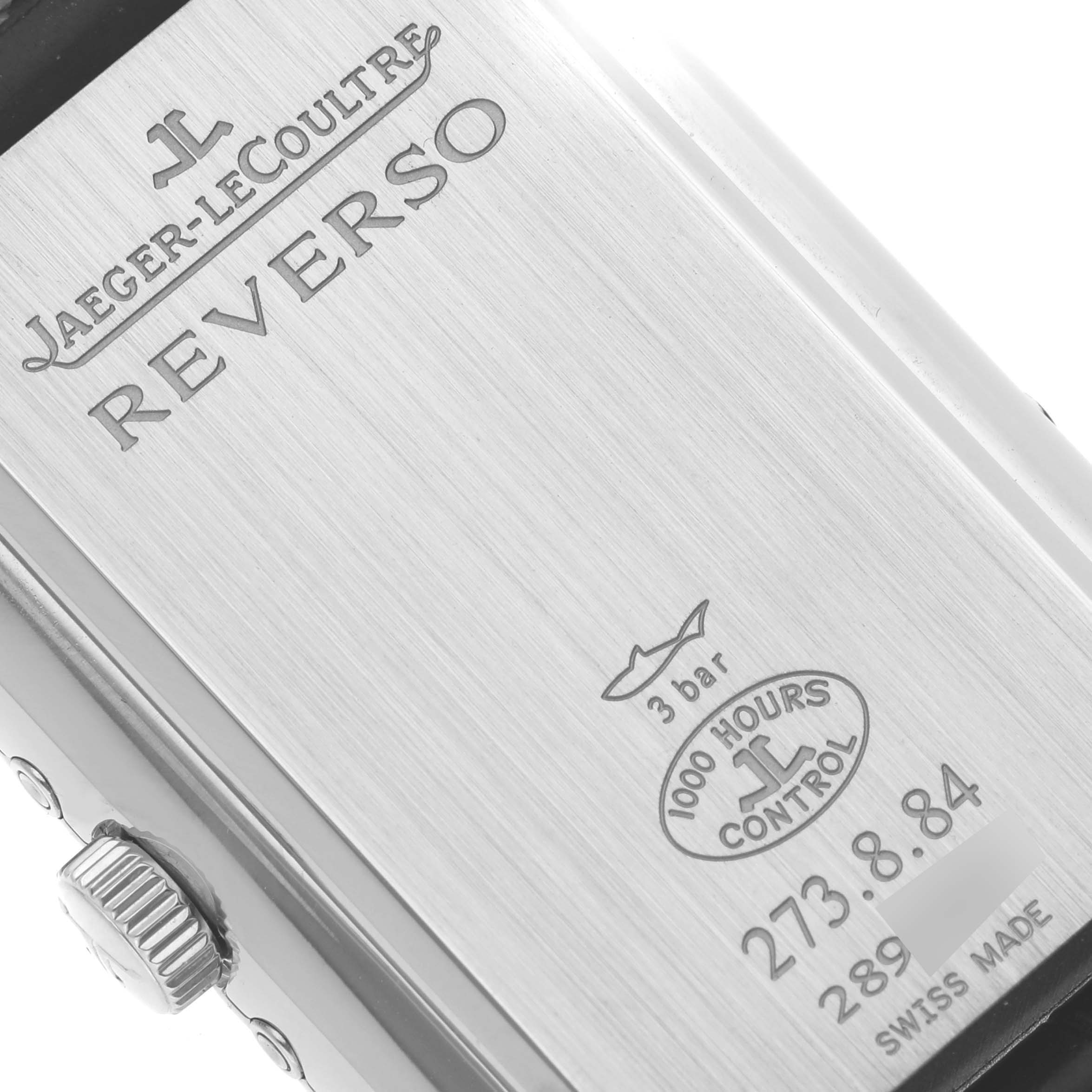 The image shows the back of a Jaeger-LeCoultre Reverso watch at an angled close-up that includes the crown.