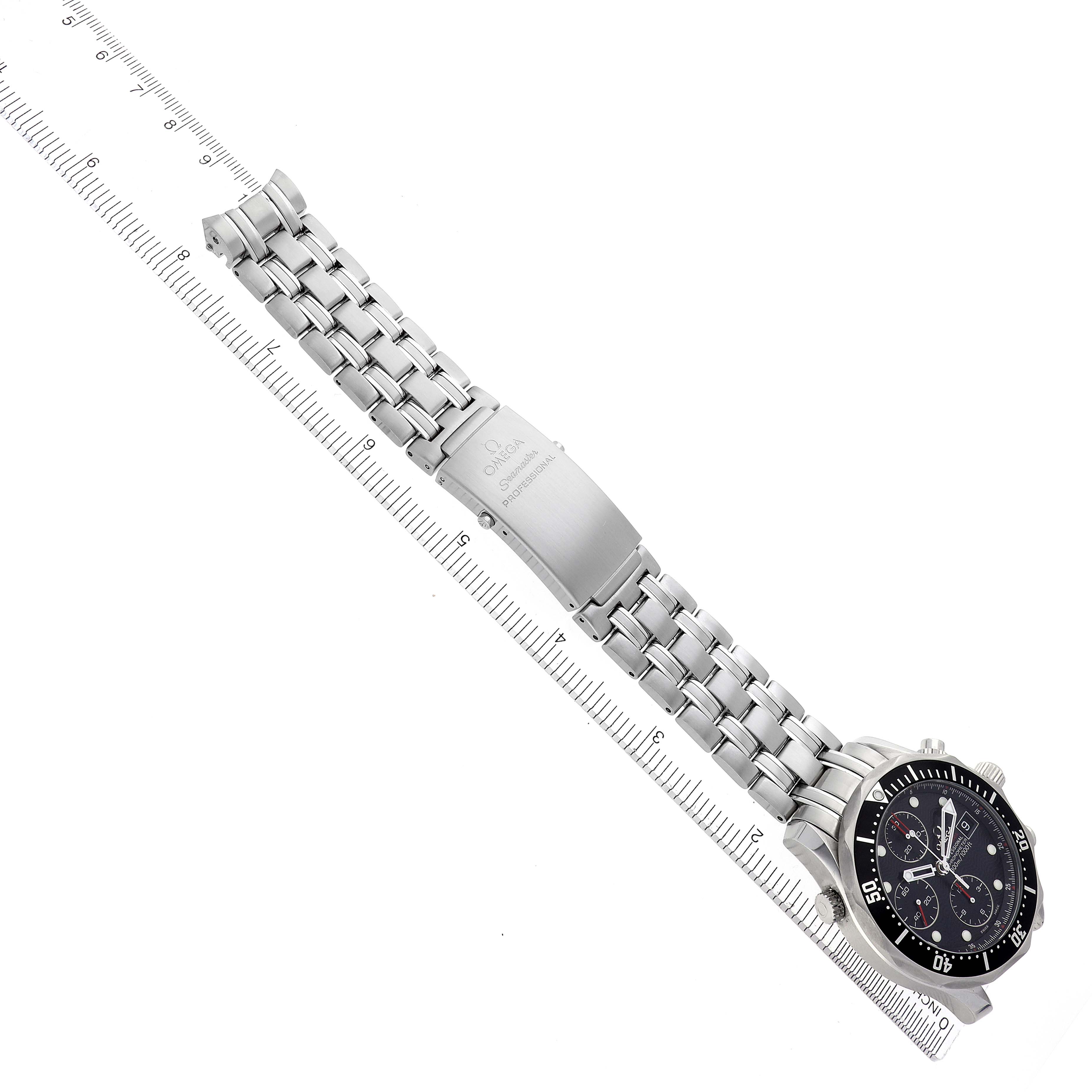 The Omega Seamaster 213.30.42.40.01.001 Men's Stainless Steel Black Dial 213.30.42.40.01.001 Men's Stainless Steel Black Dial watch is shown from an overhead angle, displaying the bracelet, clasp, and face with a ruler for scale.