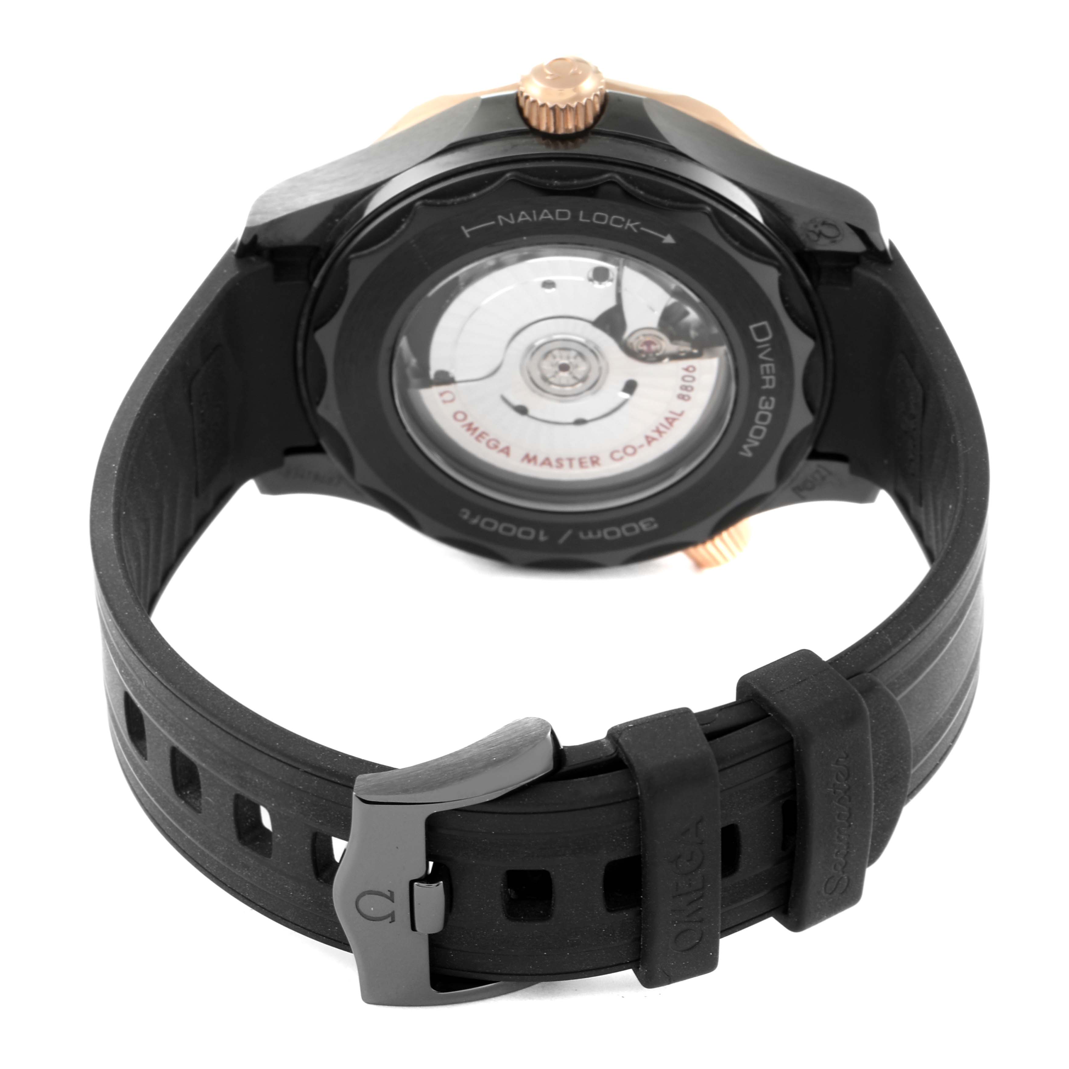 The image shows the back view of the Omega Seamaster 210.62.44.20.01.001 Men's Steel and Gold (two tone) Black Dial 210.62.44.20.01.001 Men's Steel and Gold (two tone) Black Dial watch, highlighting the movement through the transparent case back and the rubber strap.