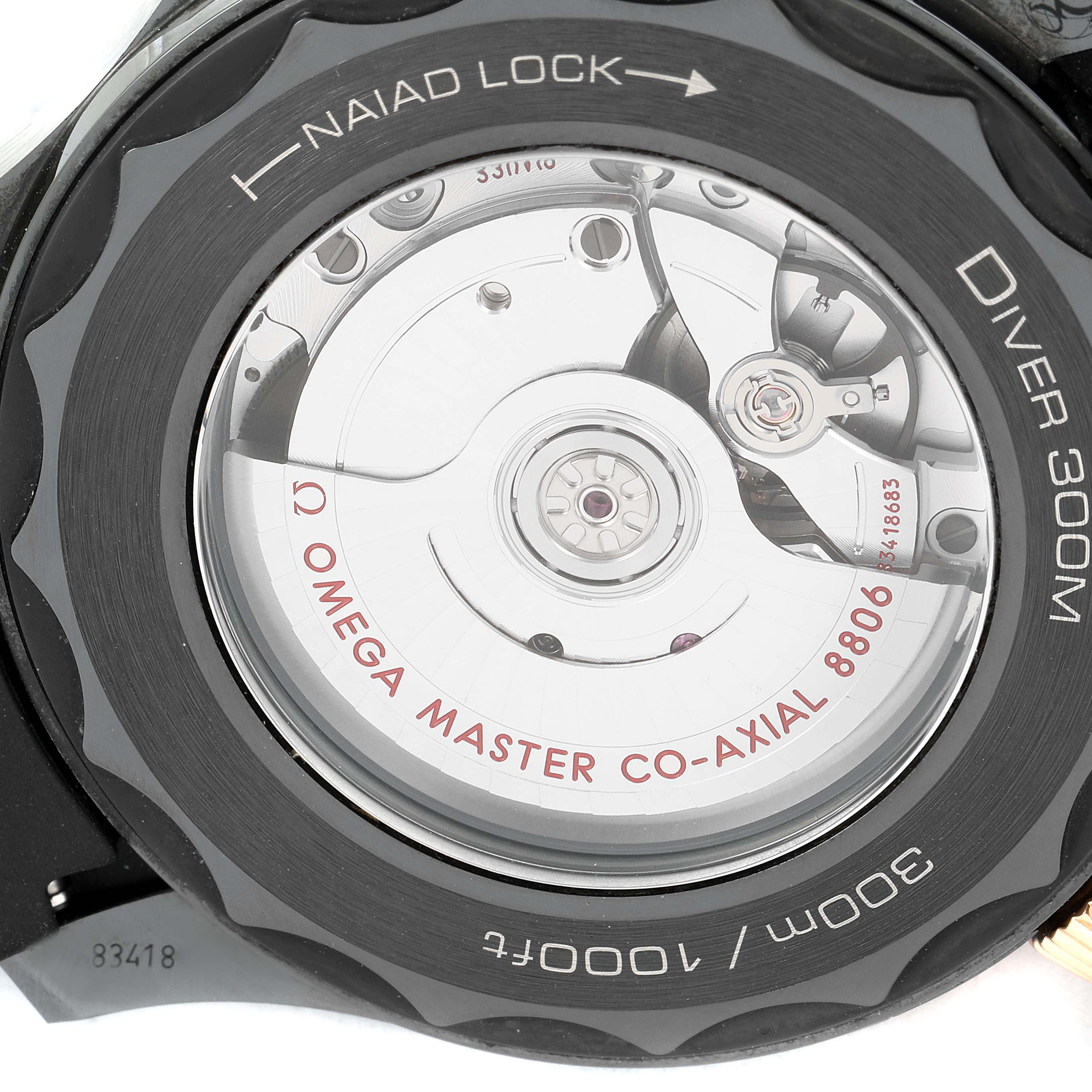 This image shows the back of an Omega Seamaster 210.62.44.20.01.001 Men's Steel and Gold (two tone) Black Dial 210.62.44.20.01.001 Men's Steel and Gold (two tone) Black Dial Diver 300M watch, highlighting its Naiad lock, movement, and Co-Axial Master Chronometer mechanism.