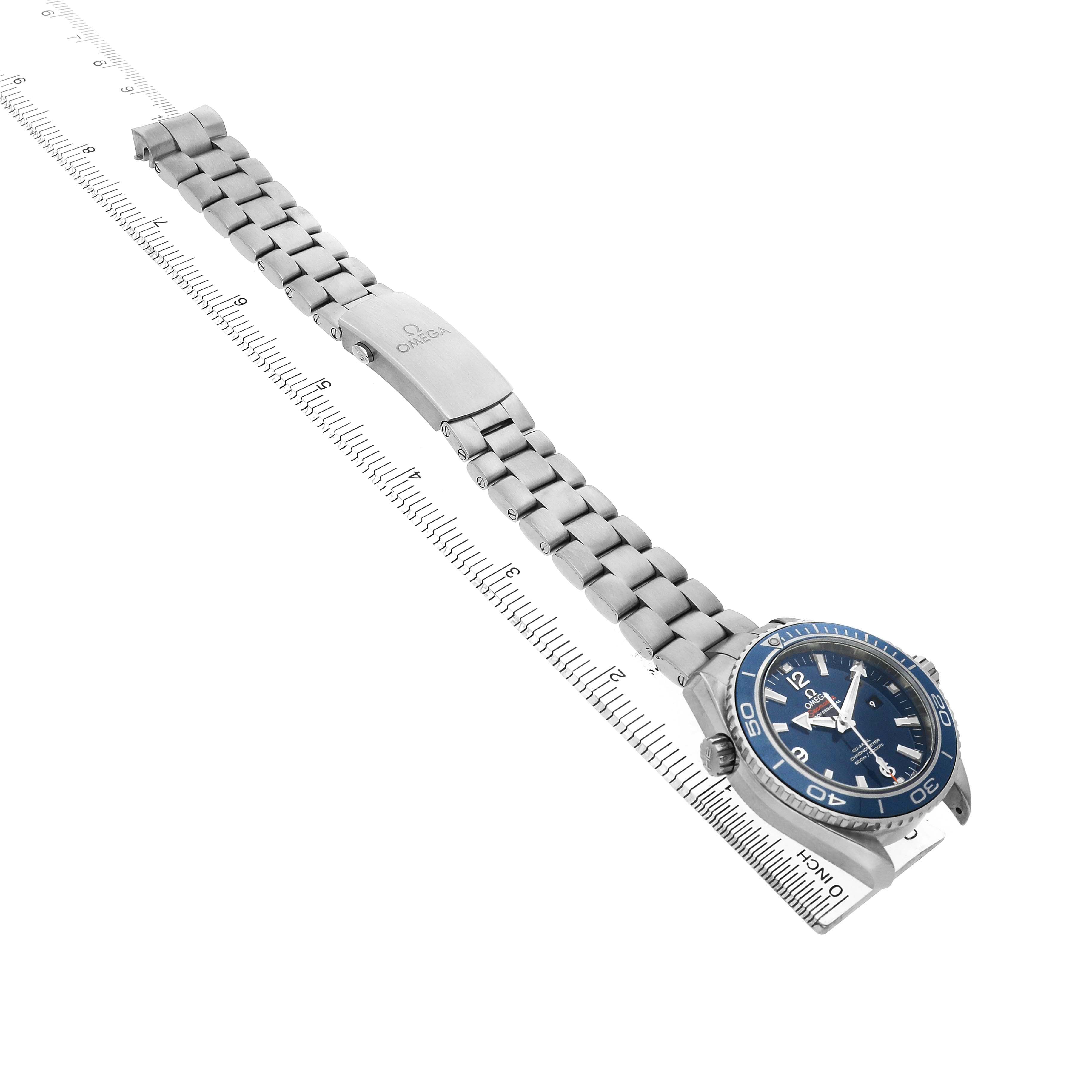 The Omega Planet Ocean 232.90.38.20.03.001 Men's Titanium Blue Dial watch is shown at an angle displaying the blue dial, bezel, crown, clasp, and bracelet.