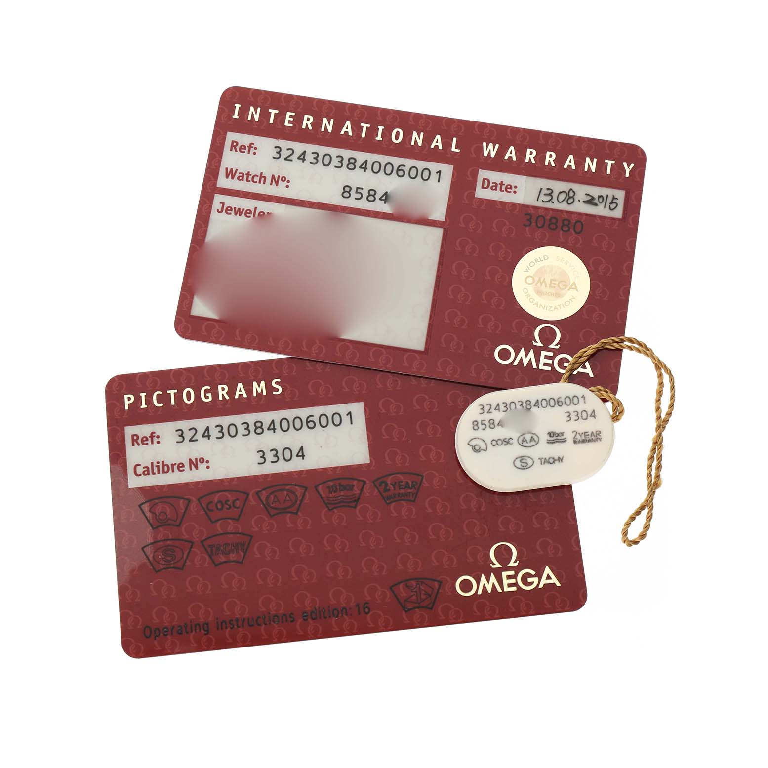 The image shows two warranty and pictogram cards for the Omega Speedmaster 324.30.38.40.06.001 Men's Stainless Steel Grey Dial, with a matching tag attached.