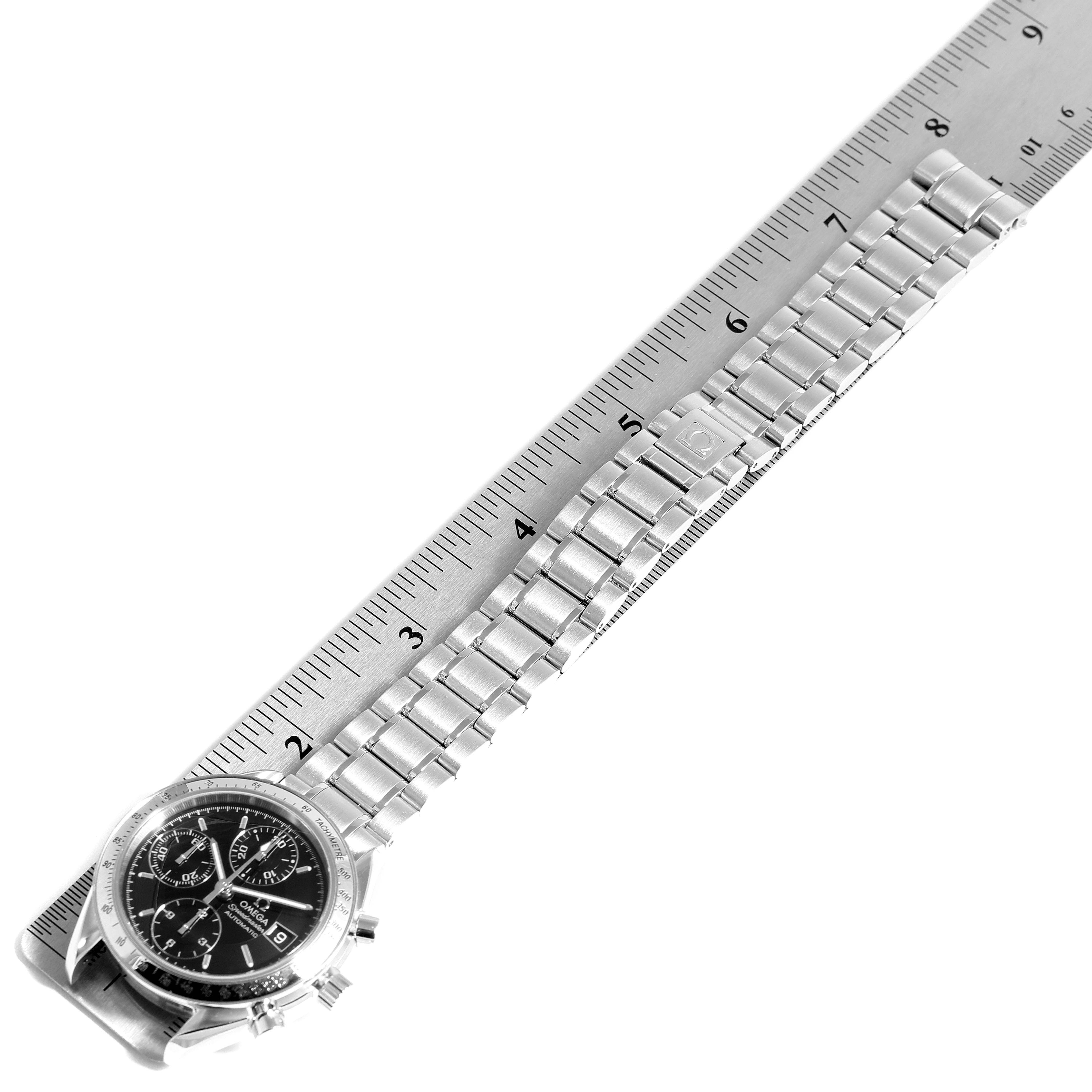 This image shows an Omega Speedmaster 3513.50.00 Men
s Stainless Steel Black Dial 3513.50.00 Men
s Stainless Steel Black Dial watch positioned alongside a ruler, highlighting its bracelet and dial.