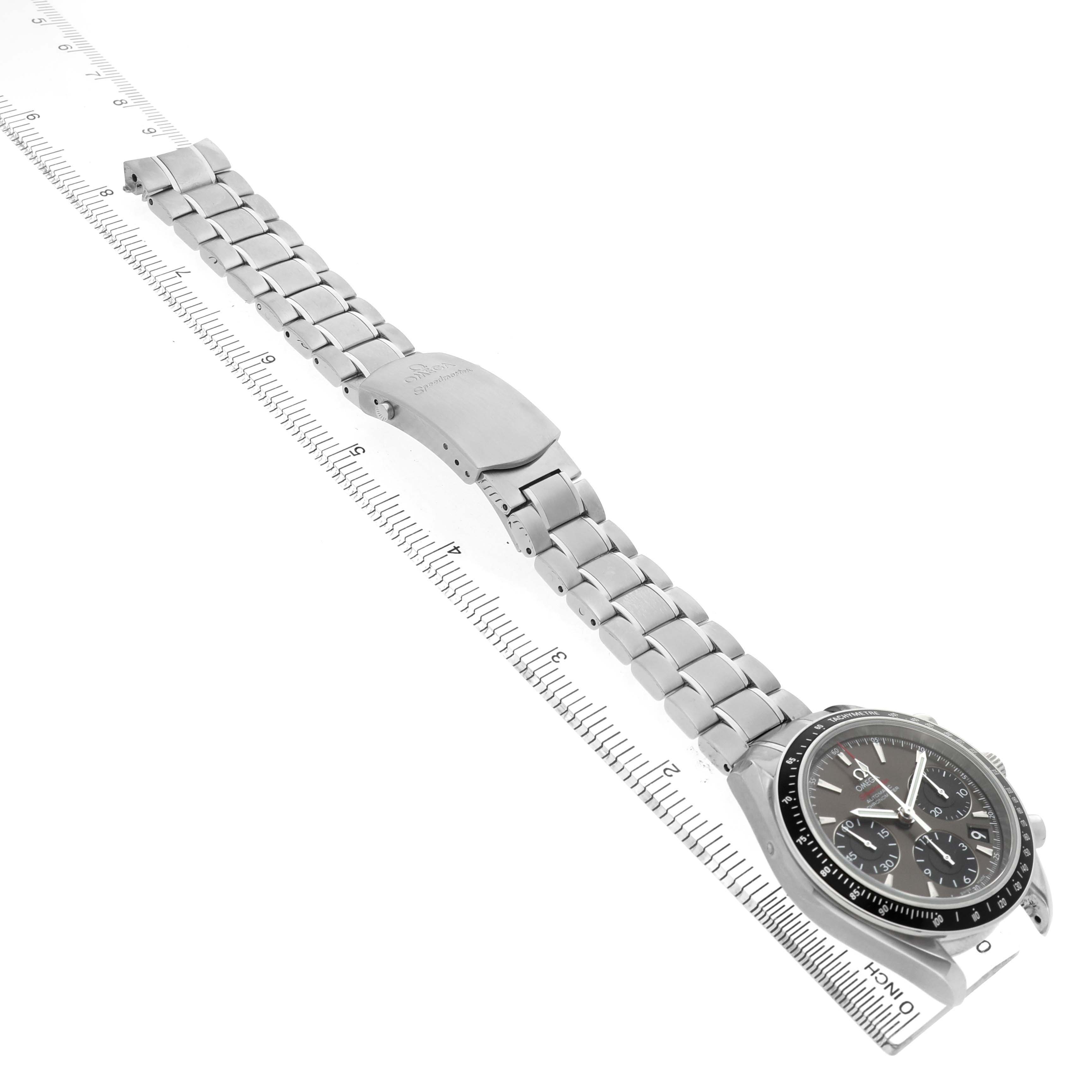 The Omega Speedmaster 323.30.40.40.06.001 Men's Stainless Steel Grey Dial watch is shown at a slight angle, displaying its face, bezel, and stainless steel bracelet alongside a ruler.