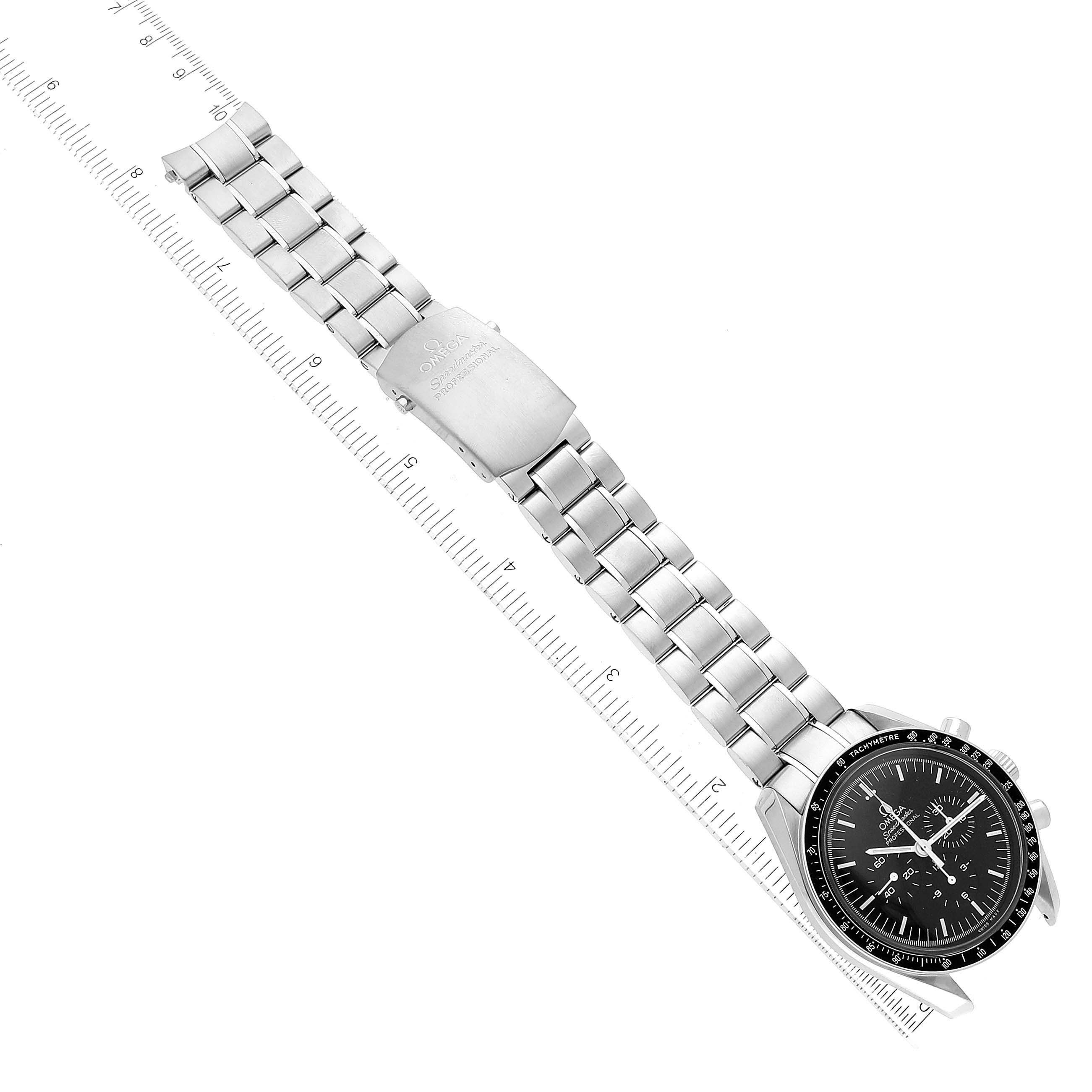 The image shows the Omega Speedmaster 311.30.42.30.01.005 Men
s Stainless Steel Black Dial 311.30.42.30.01.005 Men
s Stainless Steel Black Dial watch laid flat with the face and metal bracelet fully visible, alongside a ruler for scale.
