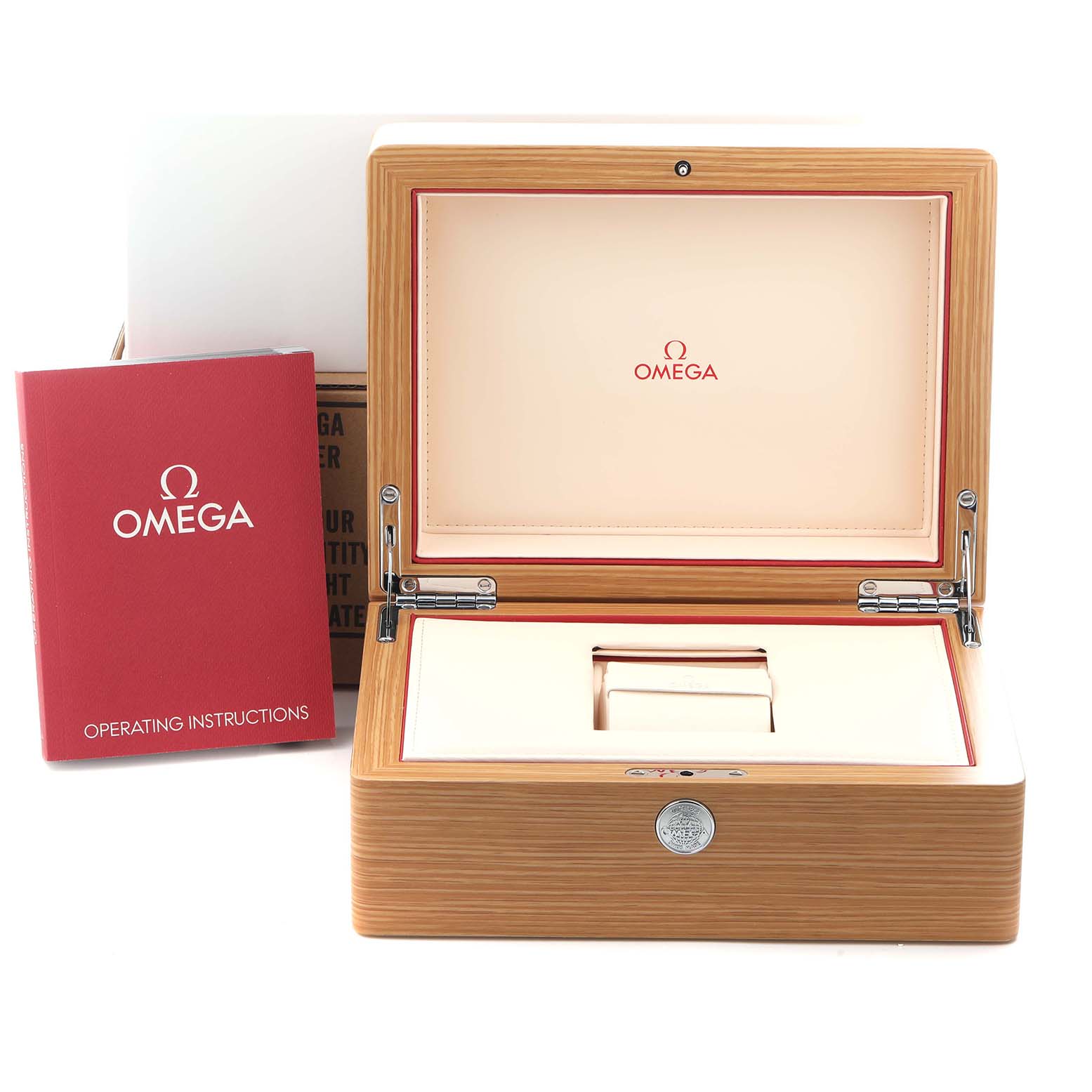 The image shows the open wooden box of an Omega Speedmaster 326.30.40.50.11.001 Men's Stainless Steel Red Dial 326.30.40.50.11.001 Men's Stainless Steel Red Dial with operating instructions next to it.