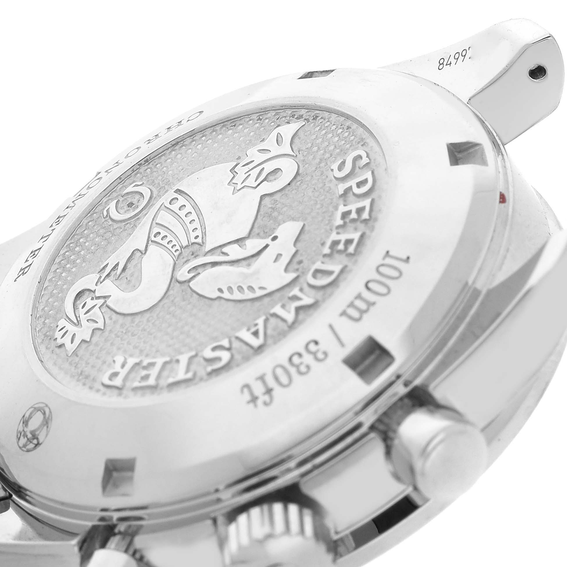 The image shows the back case and side view of an Omega Speedmaster 324.30.38.40.04.001 Men's Stainless Steel White Dial, highlighting the engraved medallion and chronograph pushers.