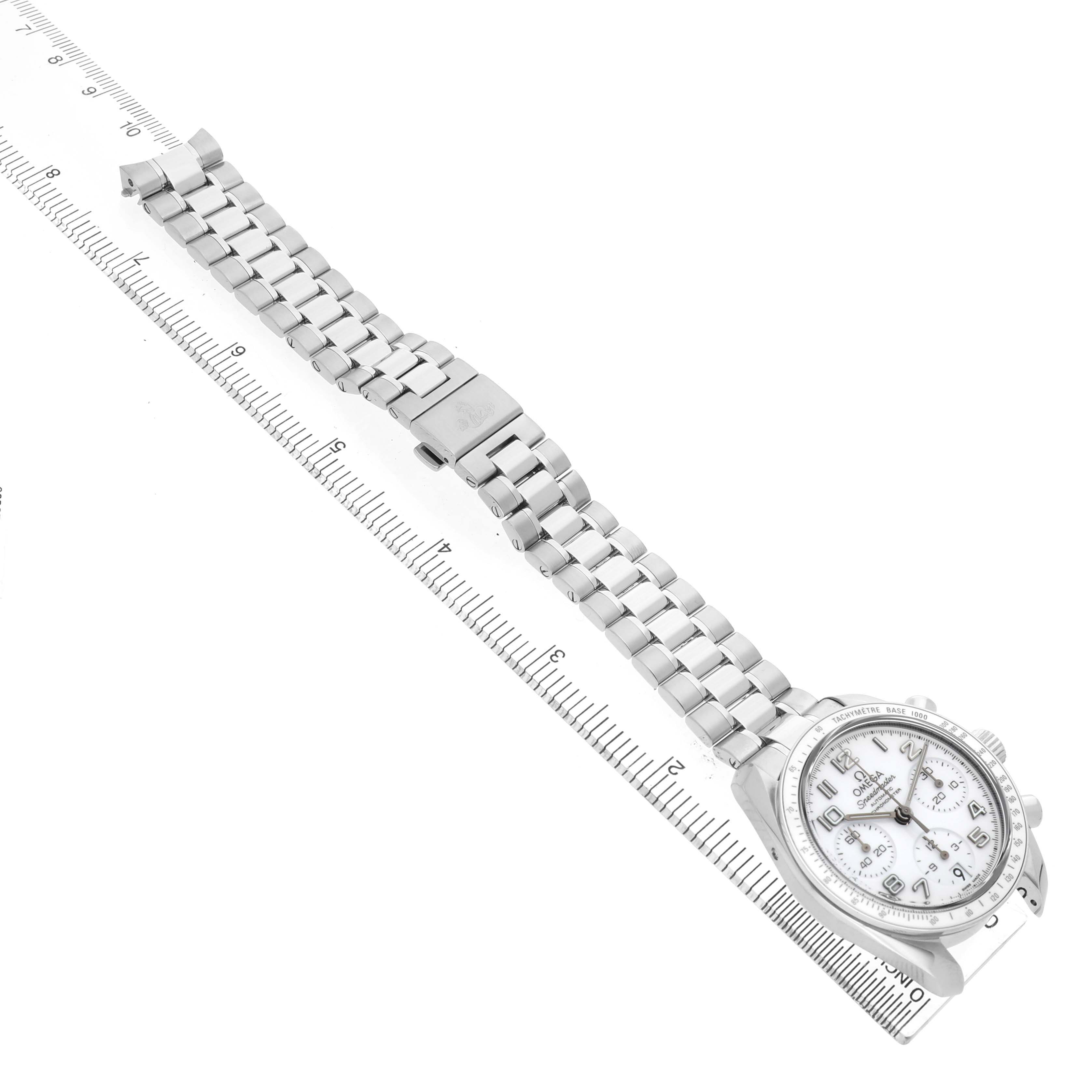 The Omega Speedmaster 324.30.38.40.04.001 Men's Stainless Steel White Dial watch is shown from a top view, highlighting its bracelet, clasp, and face alongside a ruler for scale.