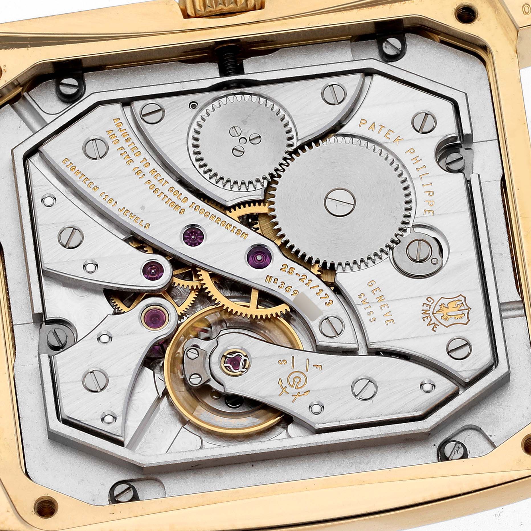This image shows the intricate inner mechanism of a Patek Philippe Gondolo 5124J Men's Yellow Gold Silver Dial 5124J Men's Yellow Gold Silver Dial watch, including gears, screws, and engravings.