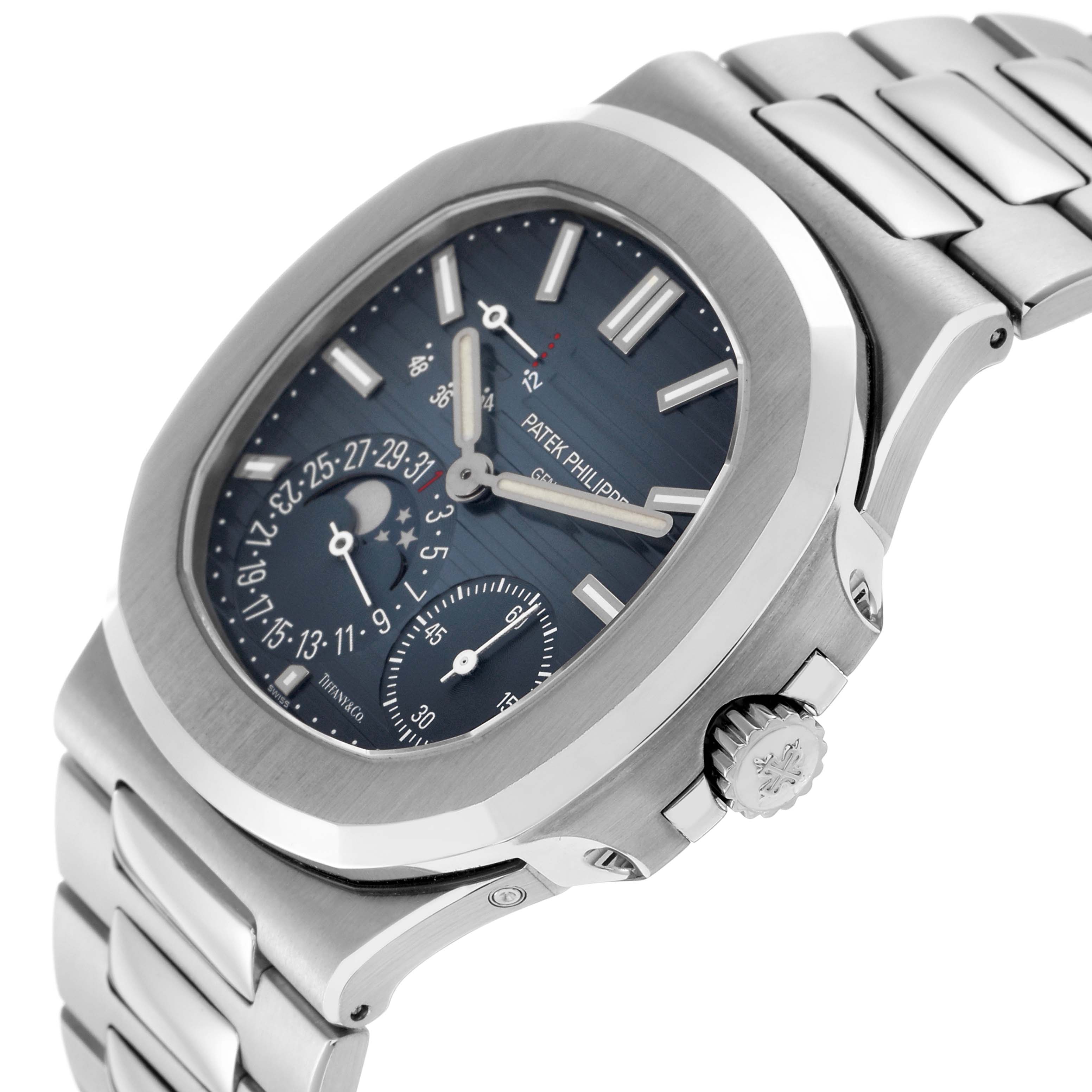 The image shows a side angle of the Patek Philippe Nautilus 5712/1A-001 Men's Stainless Steel Blue Dial, highlighting the watch face, bezel, crown, and part of the bracelet.