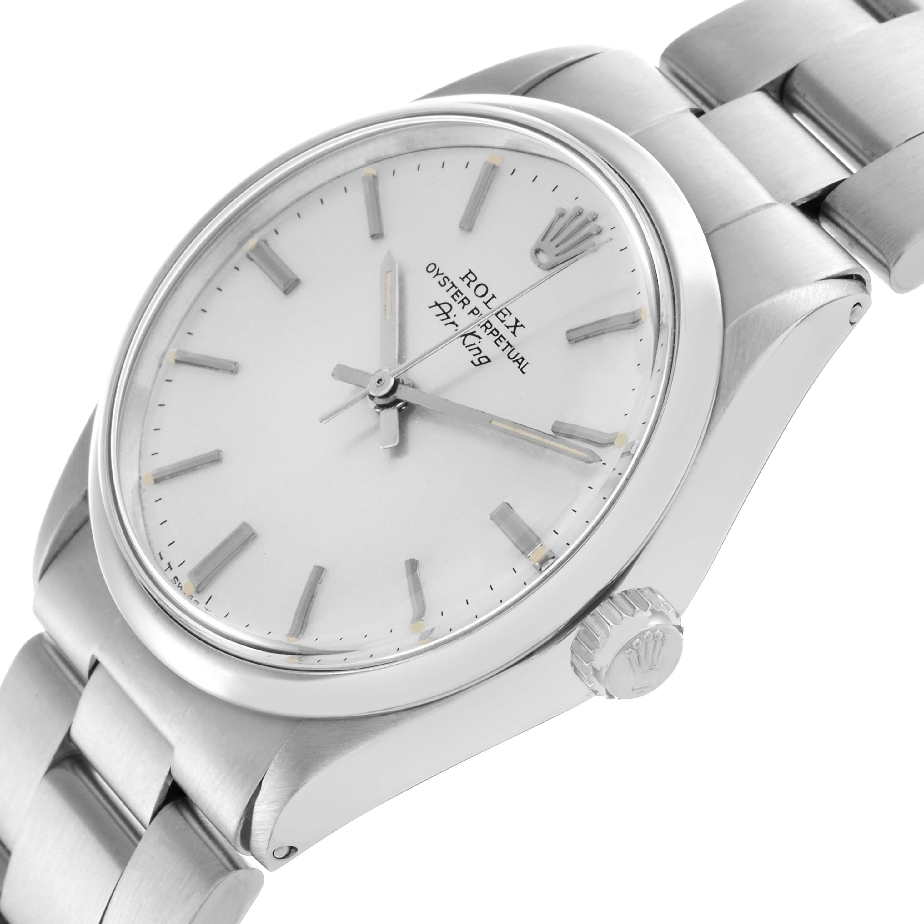 The Rolex Air-King watch is shown at a tilted angle, highlighting the dial, crown, and bracelet.