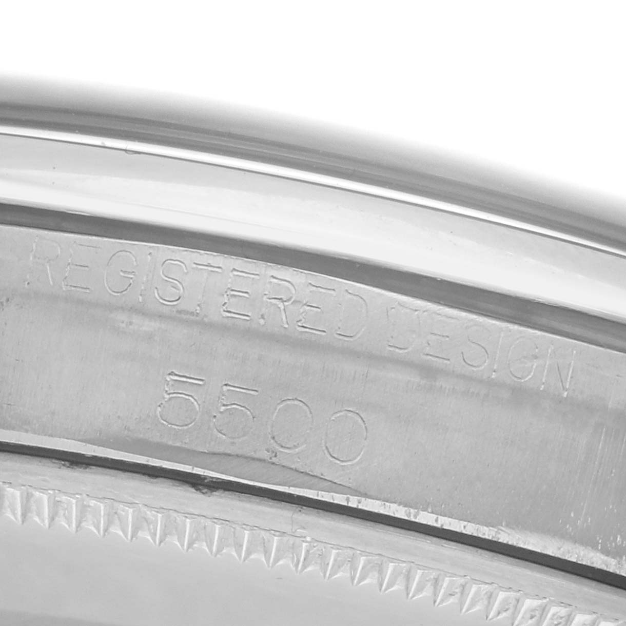The image shows the engraved case edge of a Rolex Air-King, displaying "Registered Design 5500."