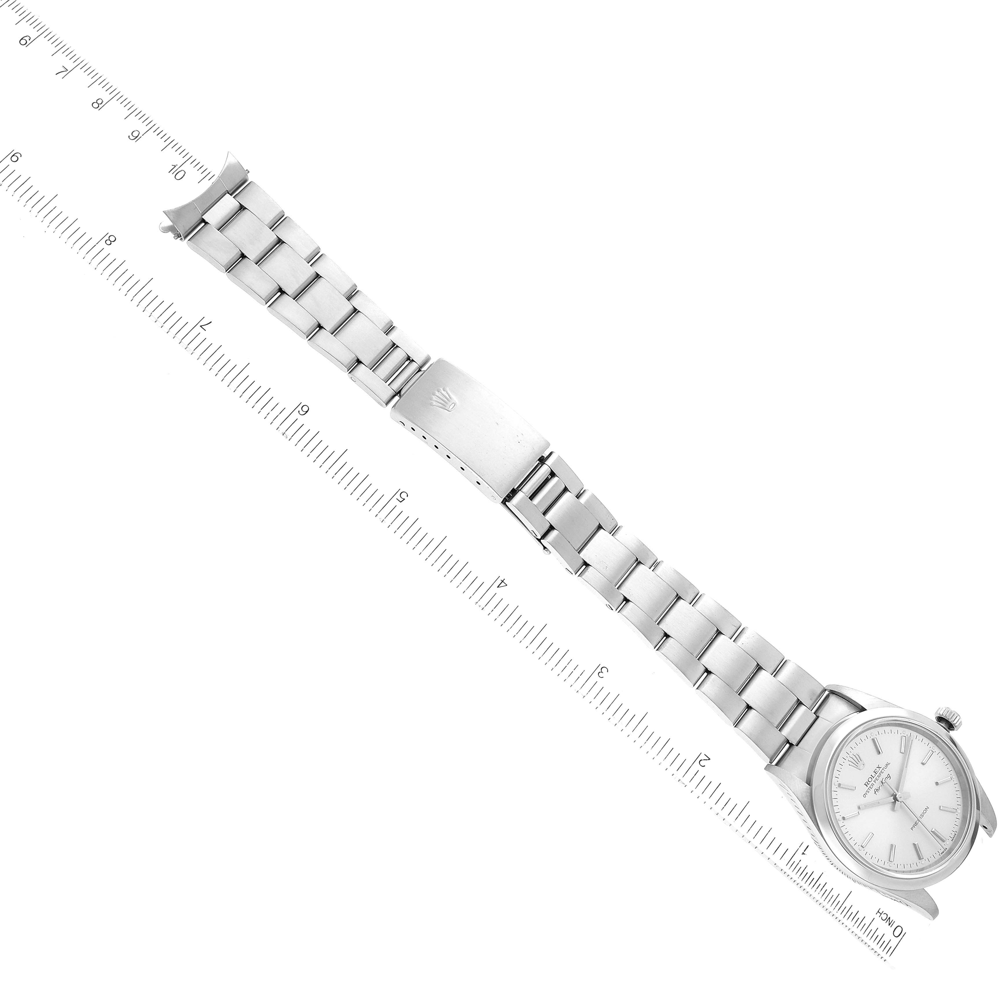 The image shows an overhead view of a Rolex Air-King 14000 Men's Stainless Steel Silver Dial 14000 Men's Stainless Steel Silver Dial watch laid flat with the dial, bracelet, and clasp visible alongside a ruler.