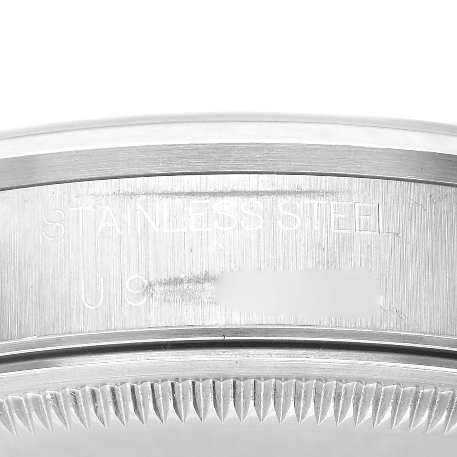 This image shows a close-up view of the side casing, serial number, and fluted bezel of a Rolex Date 15200 Men's Stainless Steel Blue Dial 15200 Men's Stainless Steel Blue Dial model.
