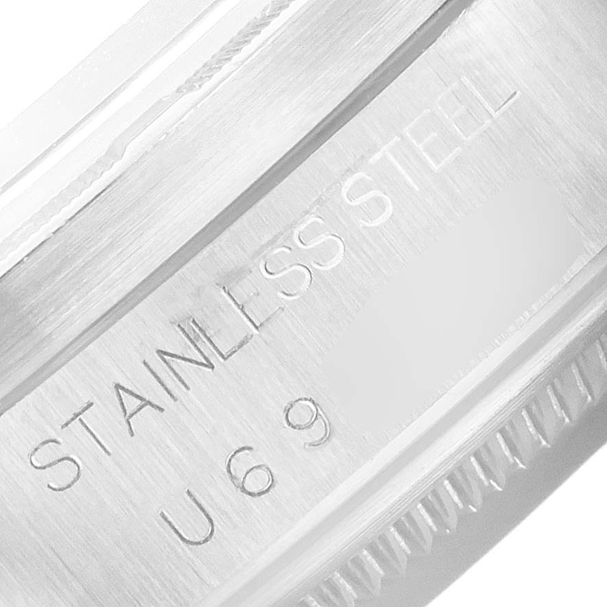 This image shows a close-up of the case back of a Rolex Date 15210 Men's Stainless Steel Pink Dial 15210 Men's Stainless Steel Pink Dial model, highlighting the "STAINLESS STEEL" engraving.