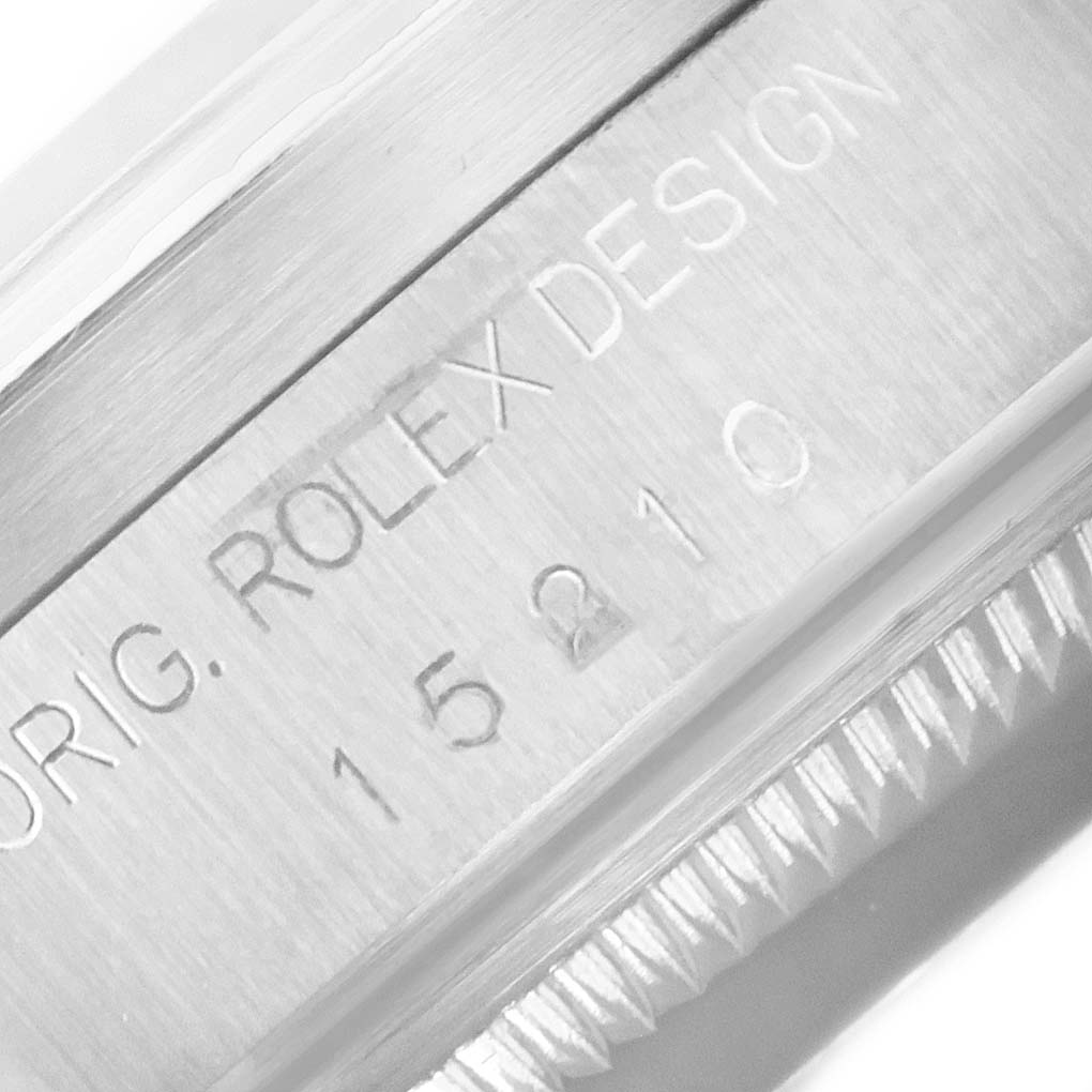 This is a close-up image showing the serial number engraving on the side of a Rolex Date 15210 Men's Stainless Steel Pink Dial 15210 Men's Stainless Steel Pink Dial model.